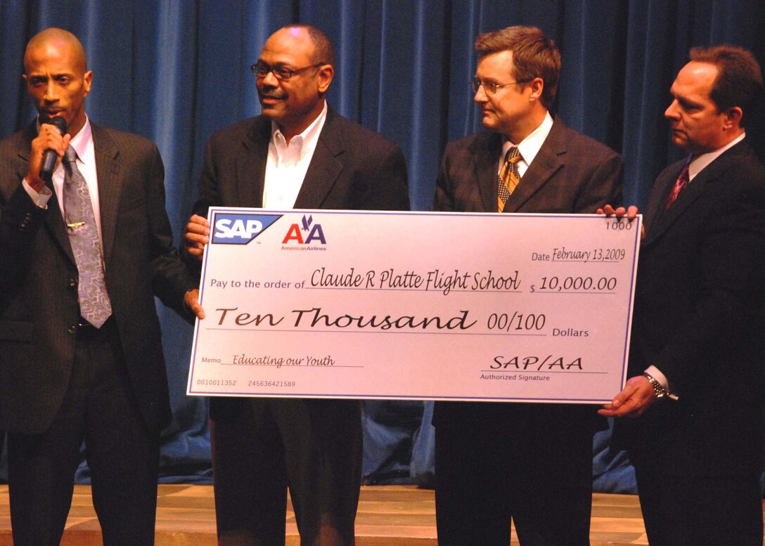 Maj. Alejandro House thanks sponsors from DFW American Airlines as they present him with a $10,000 donation towards programming for the Claude R. Future Pilots Flight School, which is located in Dallas. House, a reserve logistics officer with Marine Aviation Logistics Squadron 41, is the director of operations at the school. The CRP Flight School is comprised of original Tuskegee Airmen and serves to educate youth ages 8-18 in aviation concepts, math, science, aviation maintenance and piloting principles.