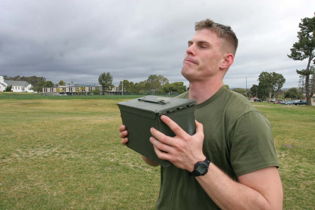 Cpl. Ryan D. O'Shea, chemical, biological, radiological and nuclear defense specialist, Headquarters and Headquarters Squadron, Marine Corps Air Station Camp Pendleton, performs the ammunition-can lift portion of the Combat Fitness Test. The CFT evaluates the combat fitness of Marines. An initial CFT is required for all Marines by March 31.
