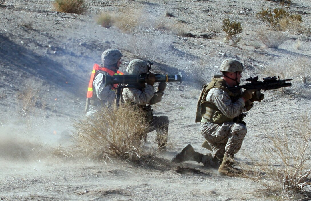 (Left to right) Capt. Roy Bechtold, Commanding Officer, Headquarters and Support Company, 2nd Reconnaissance Battalion, 2nd Marine Division, supervises Lance Cpl. Michael Cummings as he prepares to fire an AT-4 anti-tank rocket while Lance Cpl. Jason Barts provides security during the reconnaissance assault course here.  The training included simulated ambushes, setting up ambushes and familiarization with M18A1 Claymore anti-personnel mines.  The training allowed the men to practice necessary skill sets to hone their basic infantry tactics and skills.  Elements of the battalion are scheduled to deploy in support of Operation Iraqi Freedom and Operation Enduring Freedom.  (Official U.S. Marine Corps photo by Lance Cpl. David A. Weikle) (RELEASED)