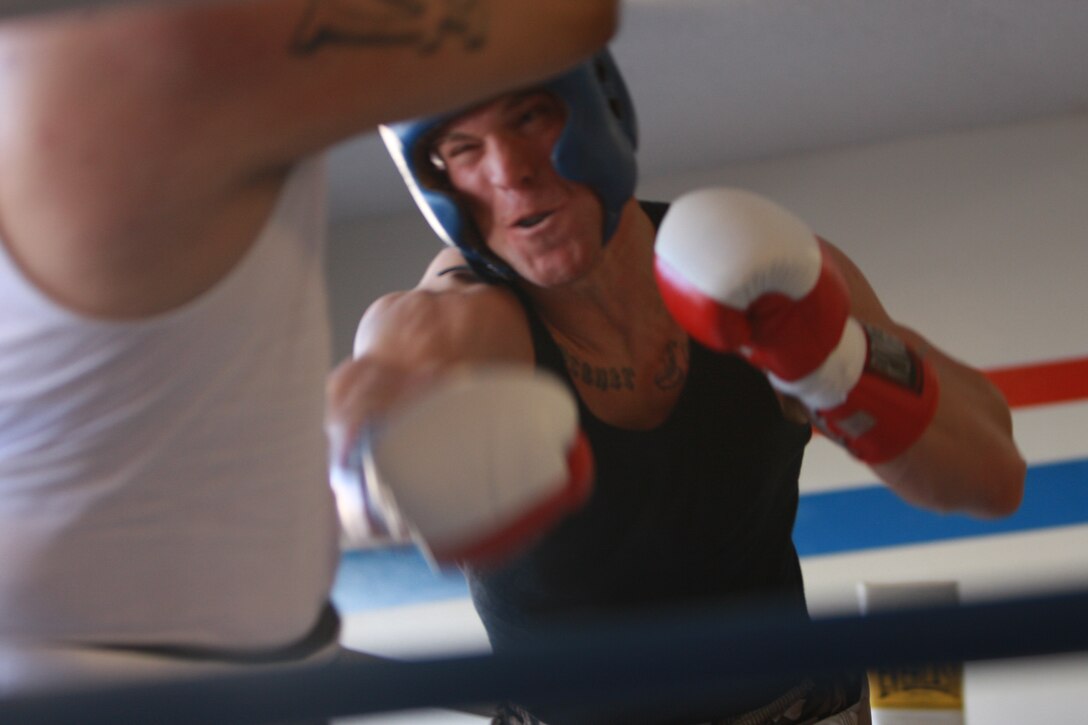 Nate Wolf, a fighter with Fight Club 29, throws a punch at his competitor Feb. 14 during a tournament at boxing club in Los Angeles. Members of Fight Club 29 took a step out of the cage and into the ring to try their hands at boxing.