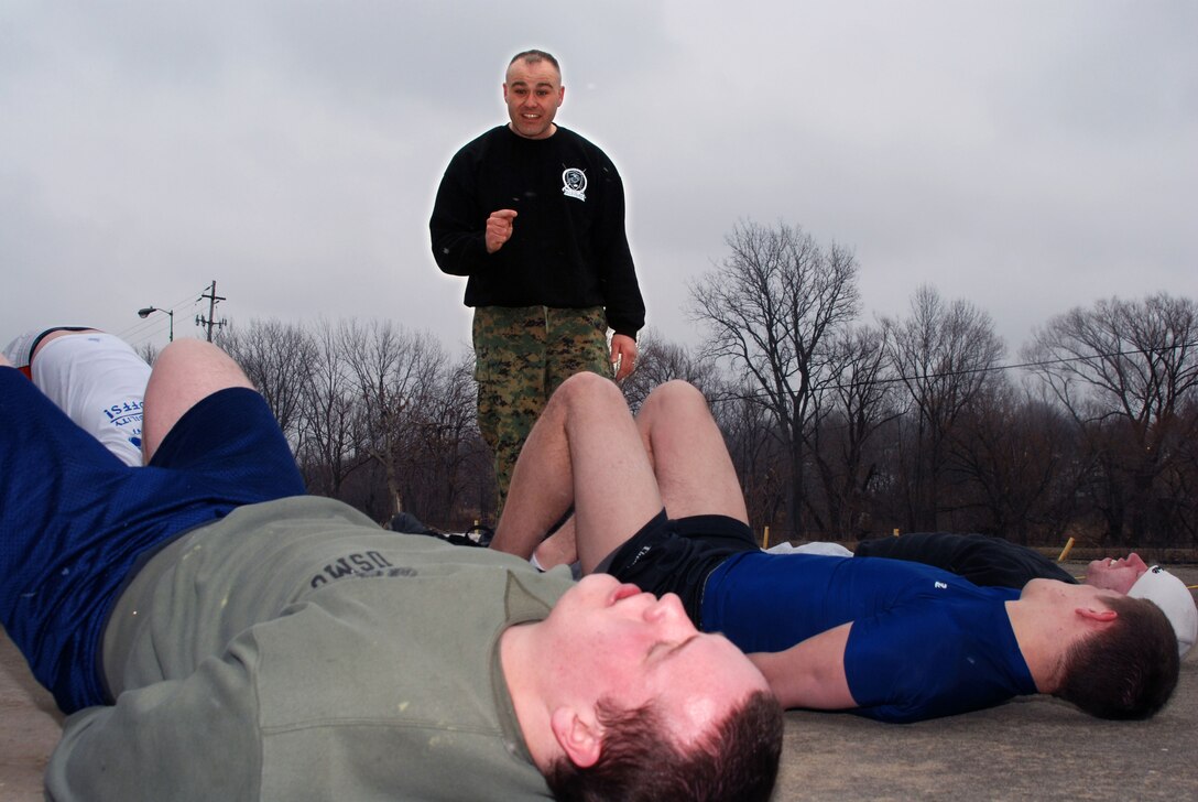 Staff Sgt. George D. Cushing motivates his pool of young men while they work-out their abdominal muscles at the Marine Corps Permanent Contact Station in Cuyahoga Falls, Ohio, Feb. 14.  In four months, Cushing has taken eight young men from Cuyahoga Falls and permanently affected their lives in a positive way. Cushing is the recruiter for Cuyahoga Falls, Recruiting Sub-Station Akron, Recruiting Station Cleveland.