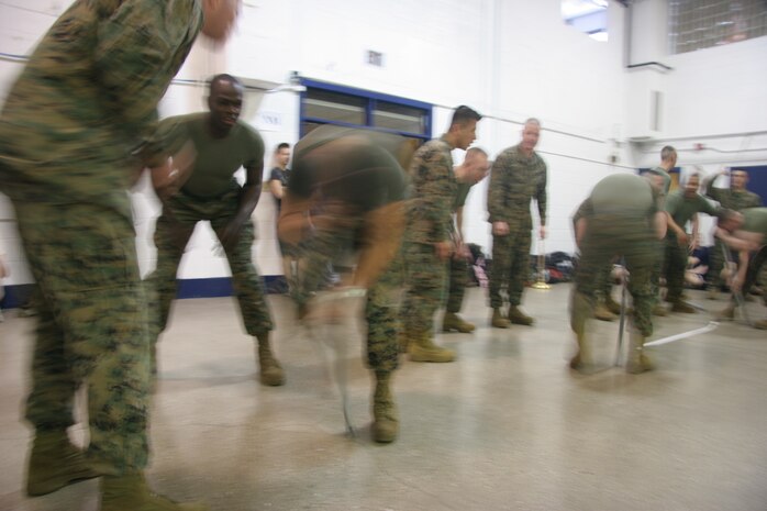 Recruiters from four of Recruiting Station Milwaukee's substations demonstrate the dizzy izzy event during the annual field meet held at the reserve center here Feb. 14. The annual event pits the four metro Milwaukee area substations against each other and fosters friendly competition which will serve the poolees well in their Marine Corps careers.