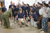 Robert Jicha, a poolee from Recruiting Substation North Milwaukee, endures the pain of the roman chair event during Recruiting Station Milwaukee's annual field meet here Feb. 14. The field meet pitted the four metro-Milwaukee substations against each other fostering friendly competition which will serve these poolees well throughout their Marine Corps career.