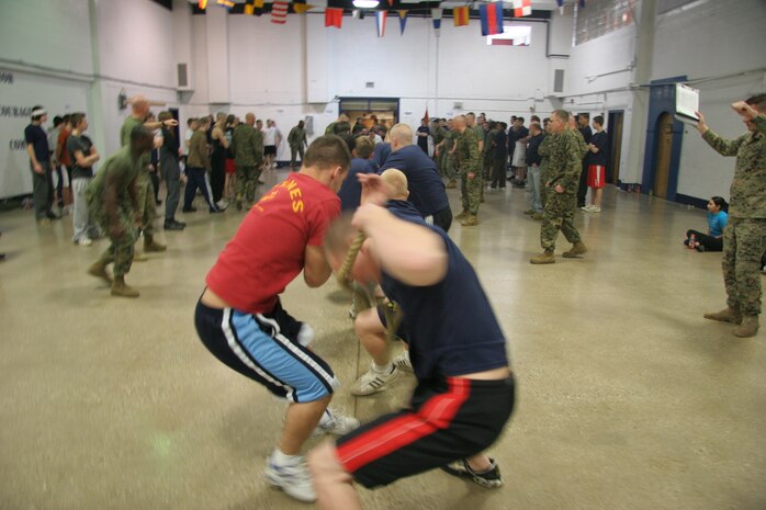 Poolees from Recruiting Substation South Milwaukee scramble to gain their footing just after the whistle blew starting the tug 'o' war portion of Recruiting Station Milwaukee's annual field meet at the reserve center here Feb. 14.