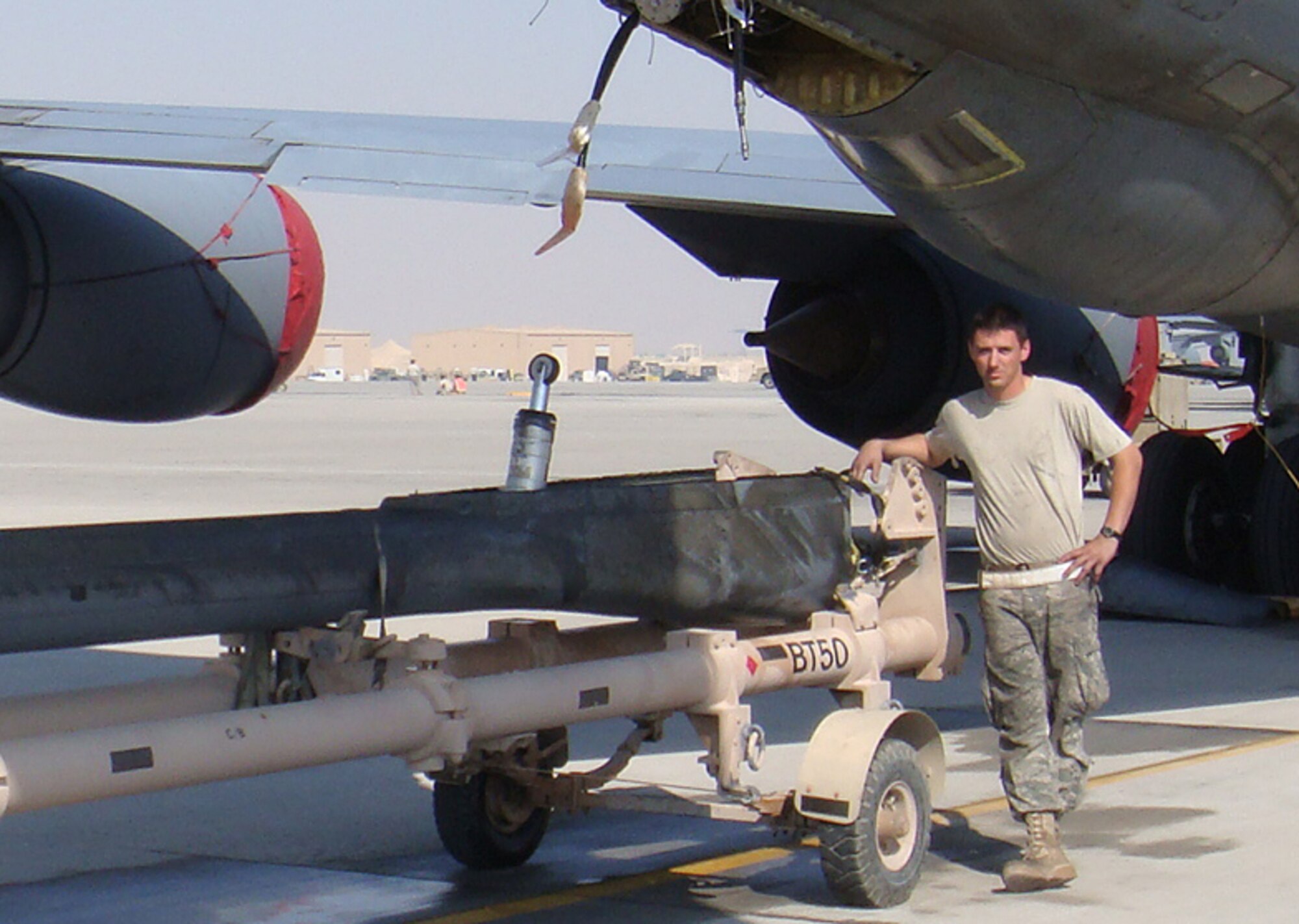 Senior Airman Travis Reimer stands with a refueling boom he helped remove from a KC-135 Stratotanker while deployed for four months in Southwest Asia. Boom removal is a long, labor-intensive process for KC-135 maintainers. Long workdays helped time move faster for Airman Reimer, a Reserve hydraulics mechanic assigned to the 931st Aircraft Maintenance Squadron at McConnell Air Force Base, Kan. (Courtesy photo)                              