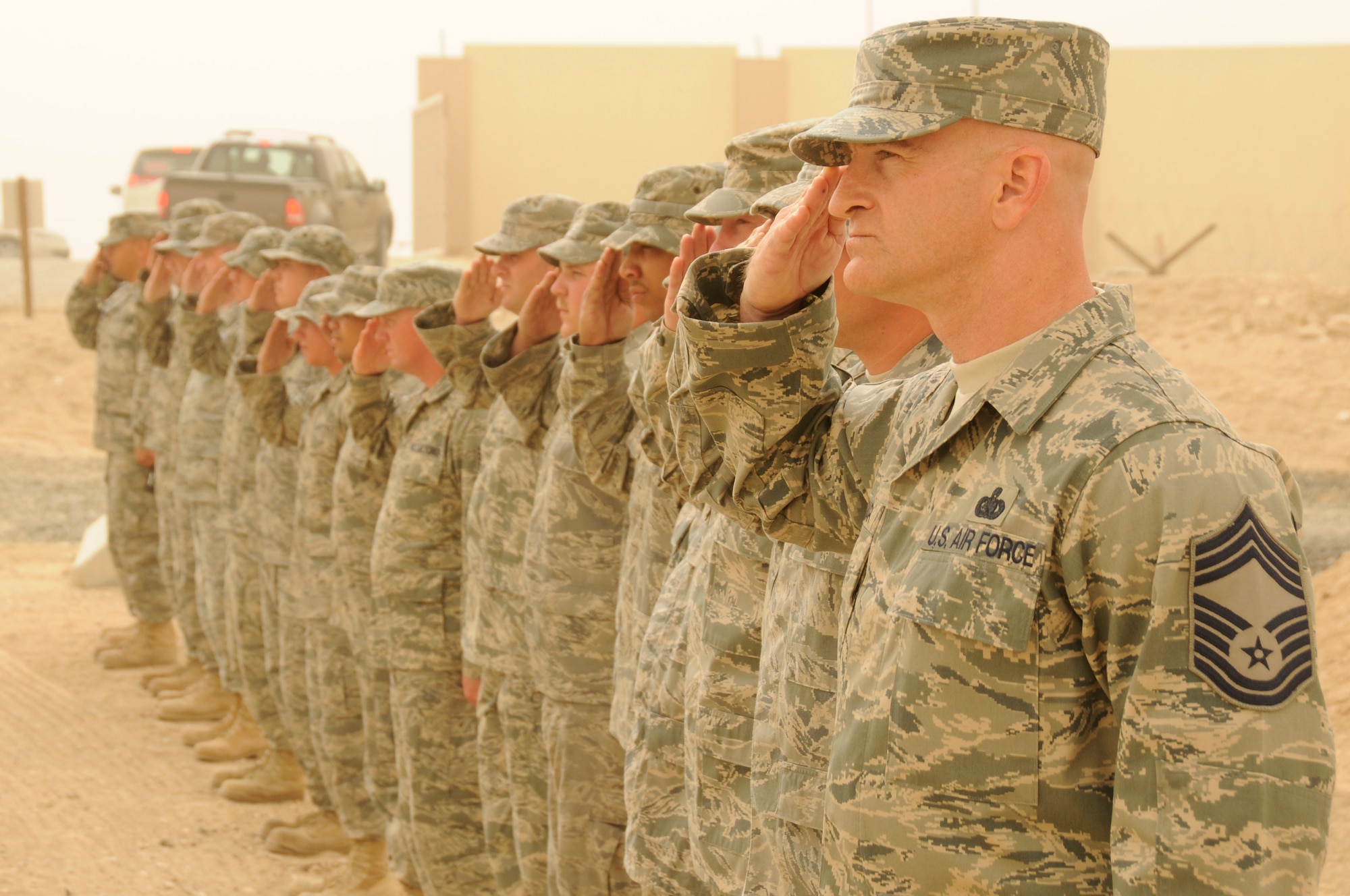 SOUTHWEST ASIA - Chief Master Sgt. George Treloar, 380th Expeditionary Logistics Readiness Squadron, fuels flight, leads the fuels flight in saluting Gen. Donald J. Hoffman, Air Force Material Command, commander, Feb 12. General Hoffman visited the 380th ELRS, fuels flight, during his tour of the 380th Air Expeditionary Wing; seeing the unit's capability and what they bring to the war on terror. General Hoffman is touring the AOR to see each bases capability. Chief Treloar is deployed from Eglin AFB and hails from Philadelphia, Pa. (U.S. Air Force photo by Senior Airman Brian J. Ellis) (Released)