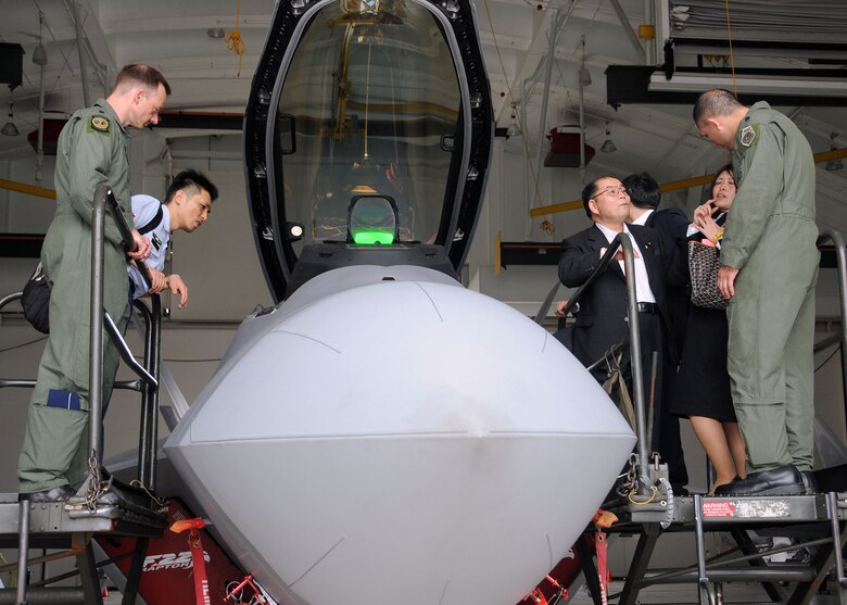ANDERSEN AIR FORCE BASE, Guam - Lt. Col. Christopher Niemi (left) and Lt. Col. Orlando Sanchez (right), 90th Expeditionary Fighter Squadron F-22 Raptor pilots, explain the F-22A Raptor’s capabilities to Seigo Kitamura, Japan’s Senior Vice Minister of Defense, and tour attendees during a site visit here Feb. 14. The site visit gave Mr. Kitamura a chance to learn about the 36th Wing mission and the annual Cope North exercise. (U.S. Air Force photo by Senior Airman Nichelle Griffiths)