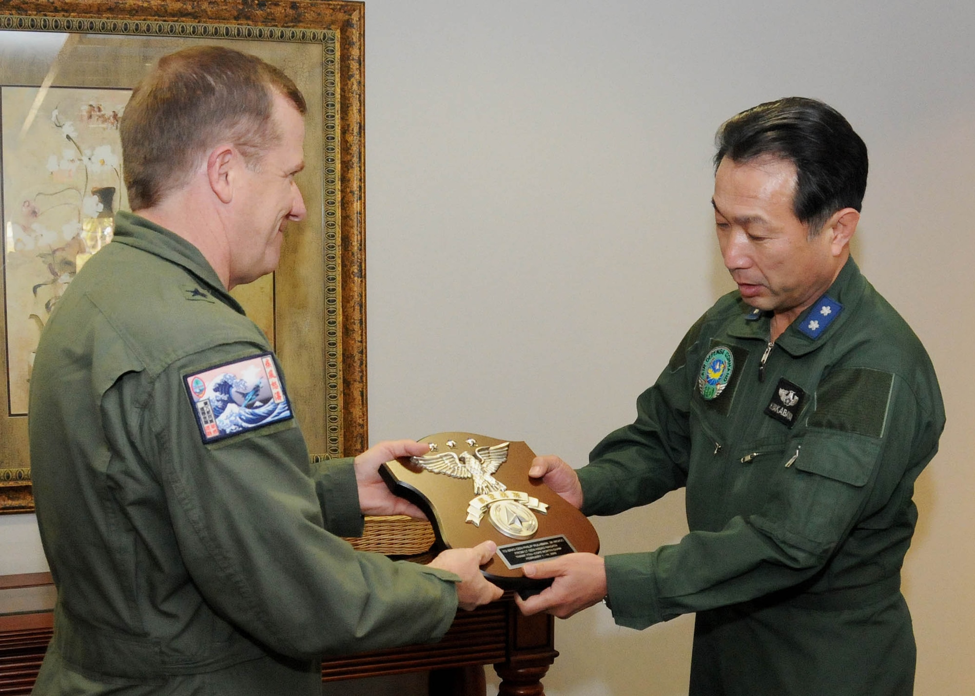 ANDERSEN AIR FORCE BASE, Guam - Maj. Gen. Hideo Wakabayashi, Japan Air Self Defense Force Command Defense Plans and Operations Chief, presents a gift on behalf of the JASDF to Brig. Gen. Phil Ruhlman, 36th Wing commander, here Feb. 12 in appreciation of the support and hospitality Team Andersen offered during the Cope North exercise. (U.S. Air Force photo by Senior Airman Nichelle Griffiths)
