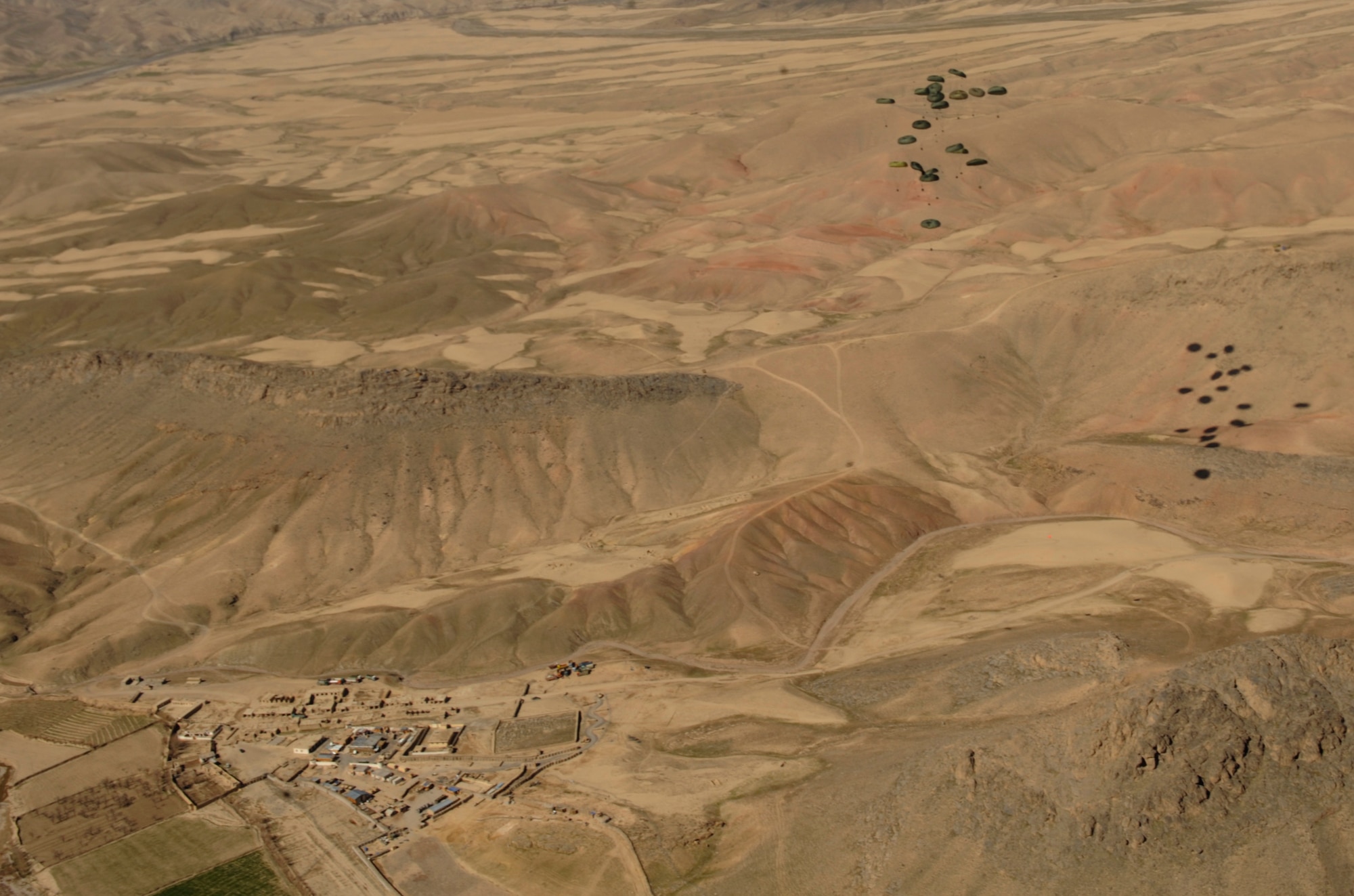 Container Delivery System (CDS) bundles fall to the drop zone after exiting an 816th Expeditionary Airlift Squadron C-17 Globemaster III during a high altitude airdrop mission in Afghanistan Feb. 14, 2009, in support of Operation Enduring Freedom.(U.S. Air Force photo by Staff Sgt. James L. Harper Jr.)Released