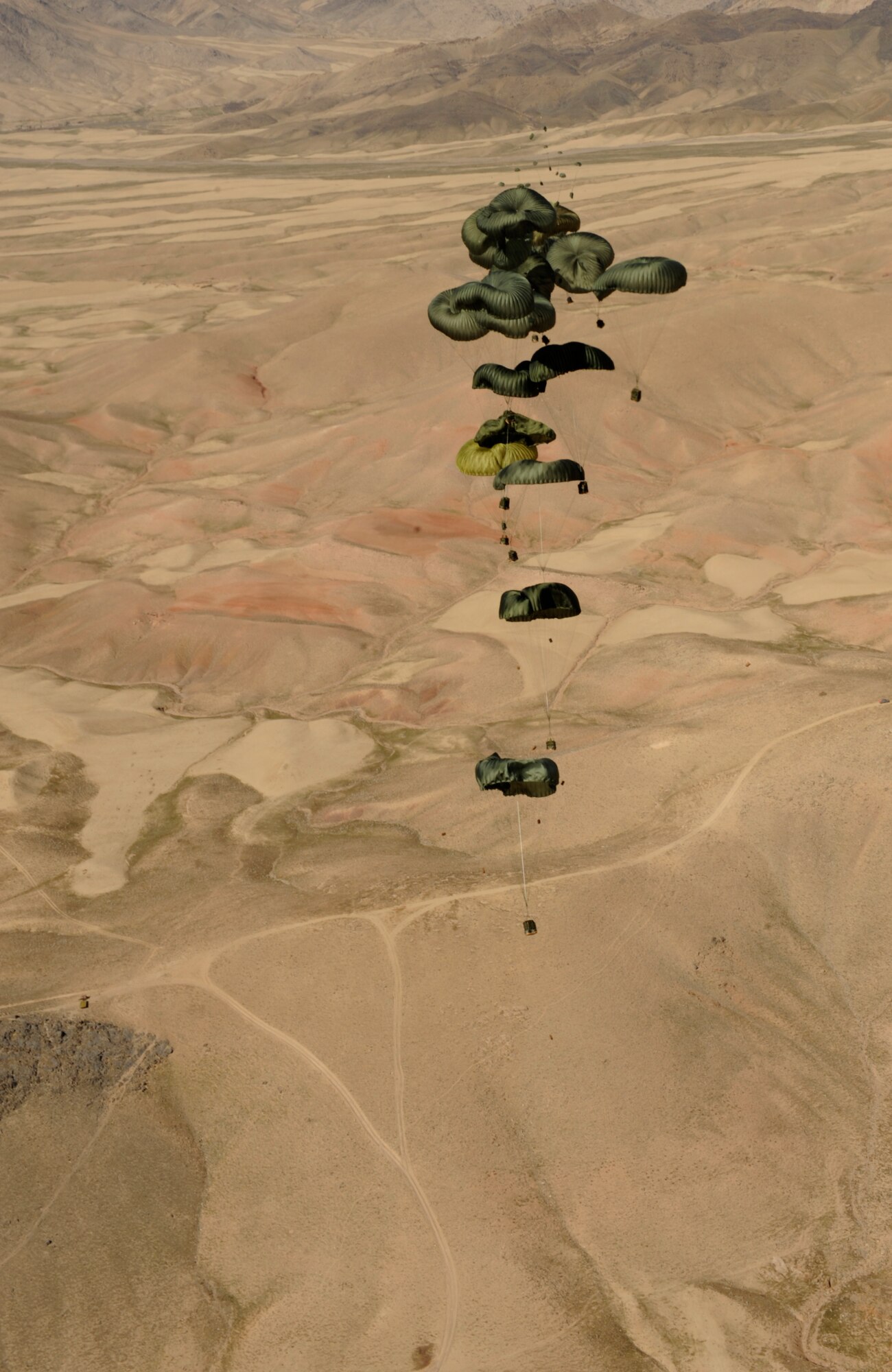 Container Delivery System (CDS) bundles fall to the drop zone after exiting an 816th Expeditionary Airlift Squadron C-17 Globemaster III during a high altitude airdrop mission in Afghanistan Feb. 14, 2009, in support of Operation Enduring Freedom. (U.S. Air Force photo by Staff Sgt. James L. Harper Jr.)Released