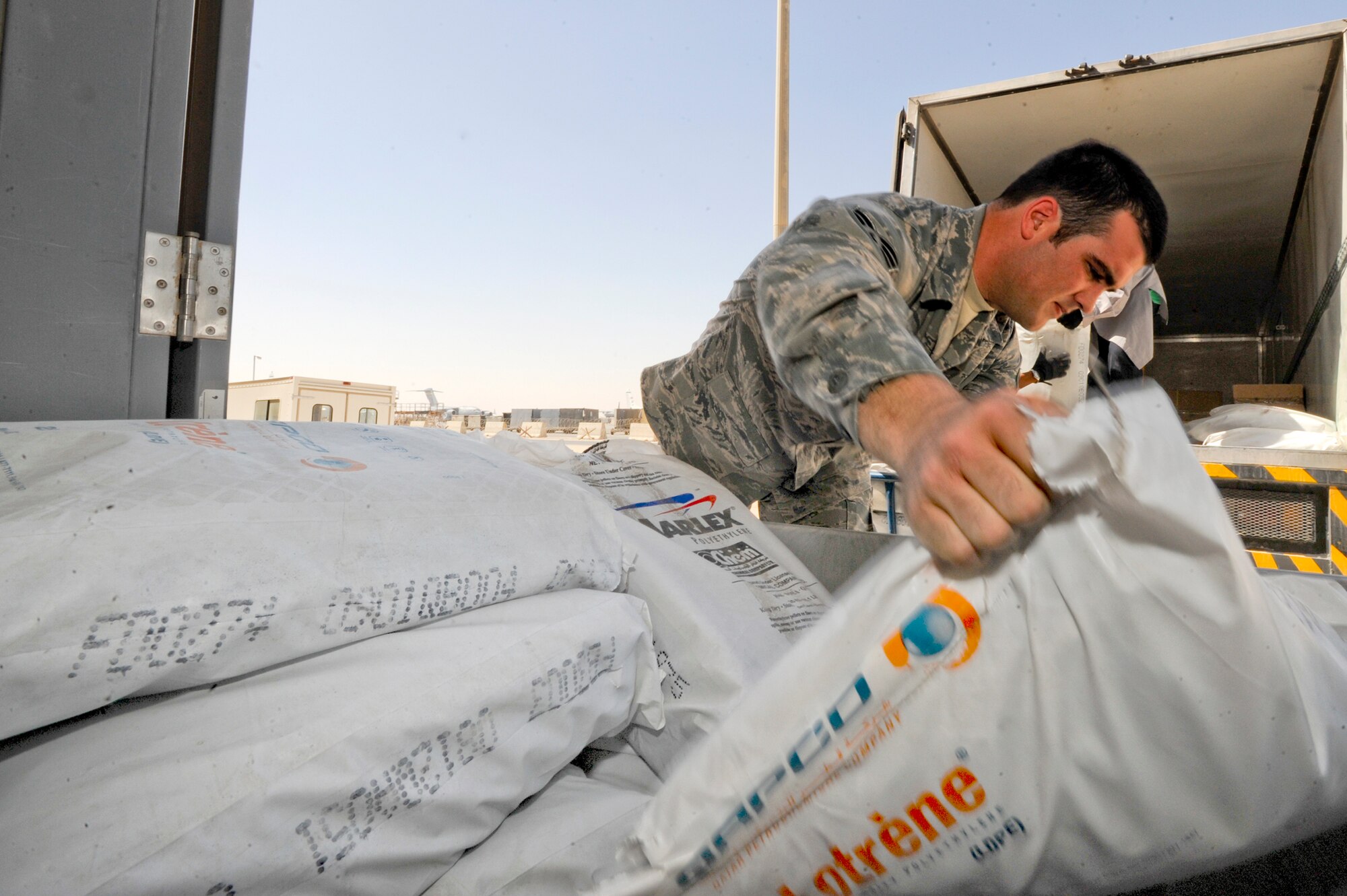 Senior Airman Joseph Connors, the 379th Expeditionary Logistic Readiness Squadron Bank Purchase Manager for the Desert Depot, off-loads a supply truck, Feb. 14, 2009, in an undisclosed location in Southwest Asia.  Airman Connors handles the requisition of supplies through local vendors in the area to supply the base with general items.  Airman Connors is native to Huntington Beach, Calif. and is deployed from Davis-Monthan Air Force Base, Ariz. in support of Operations Iraqi and Enduring Freedom and Combined Joint Task Force - Horn of Africa.  (U.S. Air Force Photo by Staff Sgt. Joshua Garcia/released)