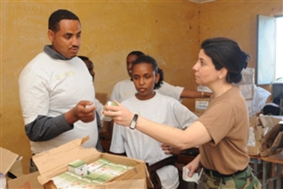 U.S. Air Force Lt. Col. Betsy Guzman, right, discusses medications with local medical volunteers during a medical civil action program in the village of Aydora, Ethiopia, Feb 3, 2009. During the program, military personnel provided medical assistance and services to tribal members who normally would go without medical care.
