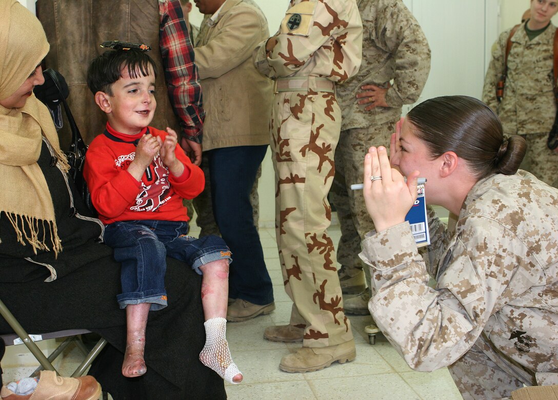 Inside the Iraqi army clinic on Camp Mejid, Iraq, a Marine from Multi National Force-West plays peek-a-boo with five-year-old Abdulrahman, who was diagnosed with congenital epidermolysis bullosa, a rare skin condition that produces painful sores and blisters and affects one in 5 million people.  Corpsmen and doctors from MNF-W and the Iraqi army worked with medical specialists in the United States to diagnose the boy's condition and bring special medical products to Iraq to help ease the boy's suffering.