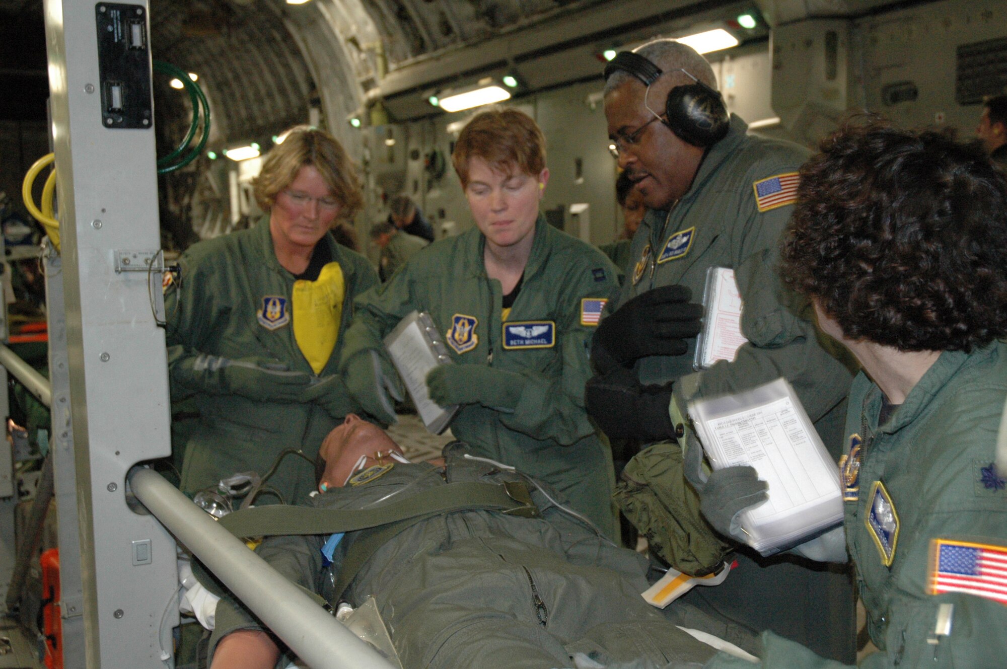 Members of the 459th Aeromedical Evacuation Squardon assess a patient being transported on  a Charleston-based C-17 Sunday as part of the Aeromedical Jamboree. The event, which took place Saturday and Sunday, included aeromedical squadrons from six bases around the country. Participants completed training aboard C-130s, C-17s and KC-135s.