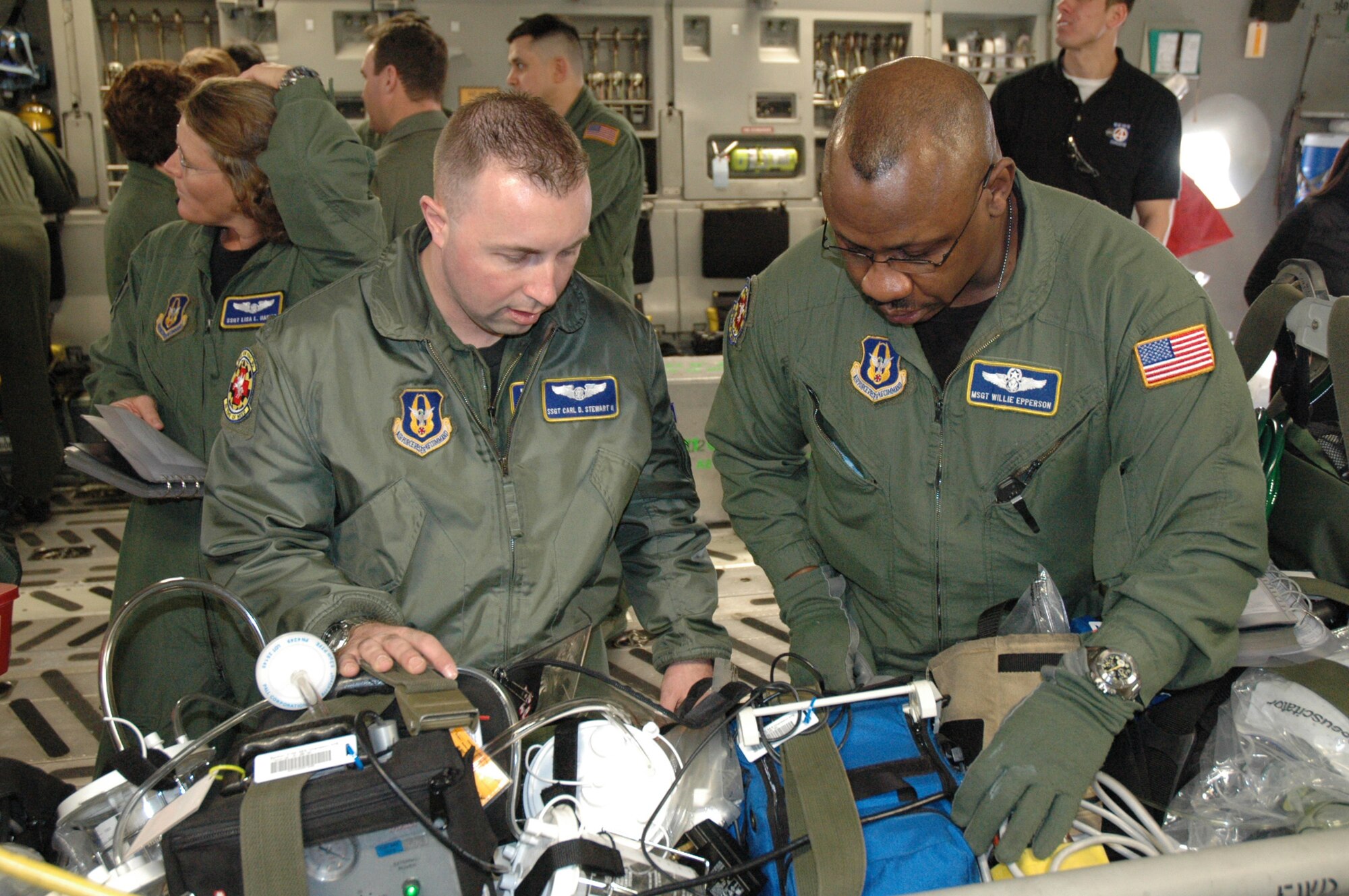 Staff Sgt. Carl Stewart and Master Sgt. Willie Epperson, both medical technicians with the 459th Aeromedical Evacuation Squardon, Andrews Air Force Base, survey equipment during the Aeromedical Jamboree here Sunday. The event, which took place Saturday and Sunday, included aeromedical squadrons from six bases around the country. Participants completed training aboard C-130s, C-17s and KC-135s.