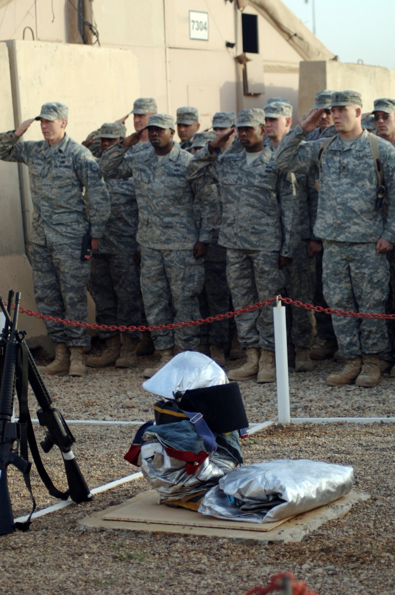 JOINT BASE BALAD, Iraq ? First-responders, from across Balad, salute the U.S. flag as it?s raised to half-mast during a memorial ceremony honoring fallen firefighter, Staff Sgt. Ray Rangel. Feb. 13 marked the four-year anniversary of Rangel?s death. The flag will be retrieved at the end of the duty day and sent to Rangel?s family in the U.S. (U.S. Air Force photo/Staff Sgt. Dilia Ayala)