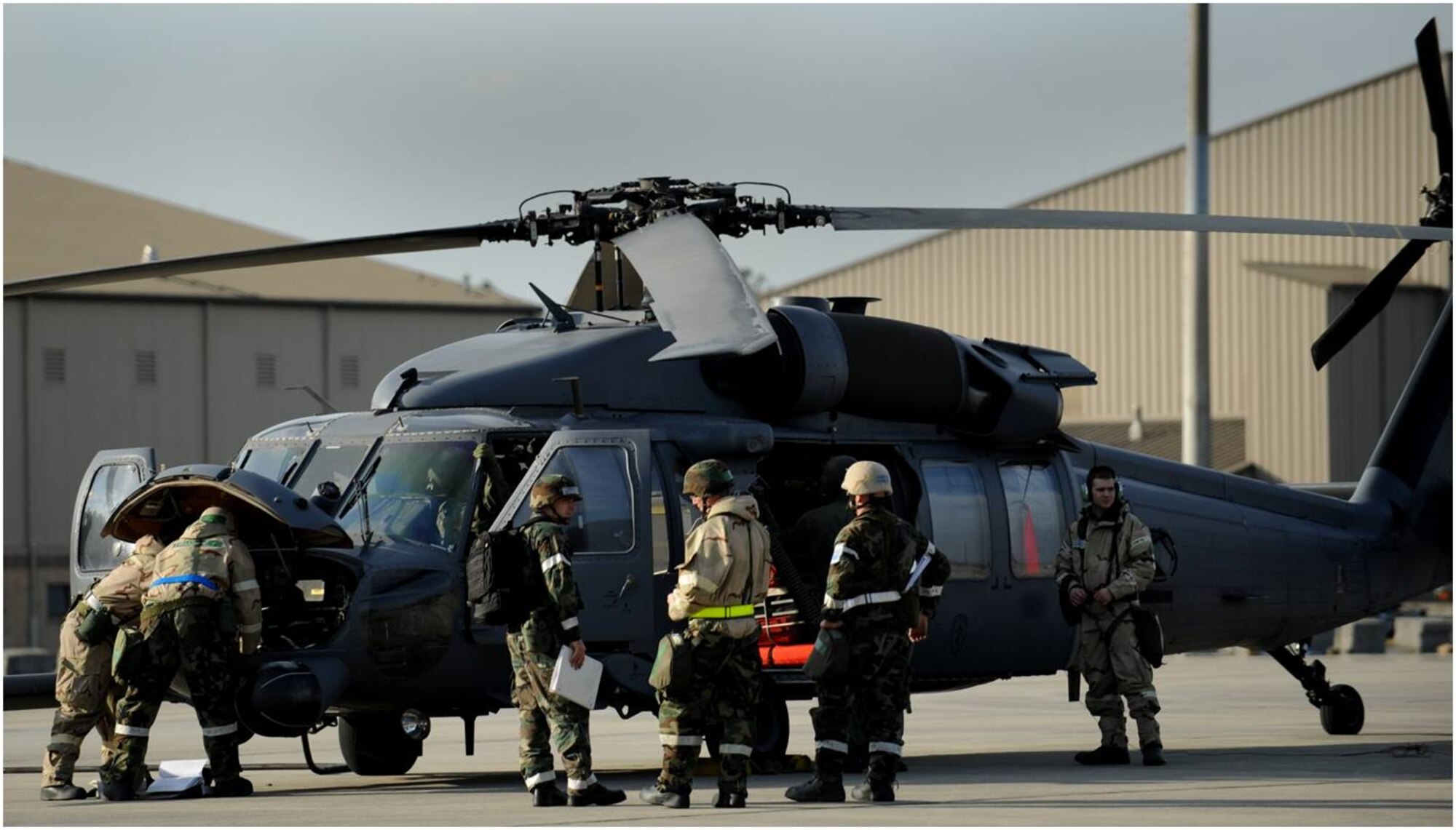 MOODY AIR FORCE BASE, Ga. -- Members of the 723rd Aircraft Maintenance Squadron perform maintenance on an HH-60G Pave Hawk helicopter during the Phase II Operational Readiness Exercise Feb. 9-13 here.  The HH-60G's primary mission is to conduct day or night combat search and rescue operations into hostile environments to recover downed aircrew or other isolated personnel during war.  It also provides civil search and rescue, emergency aero-medical evacuation, disaster relief, international aid, counterdrug activities and NASA space shuttle support.  (U.S. Air Force photo by Senior Airman Gina M. Chiaverotti)  
