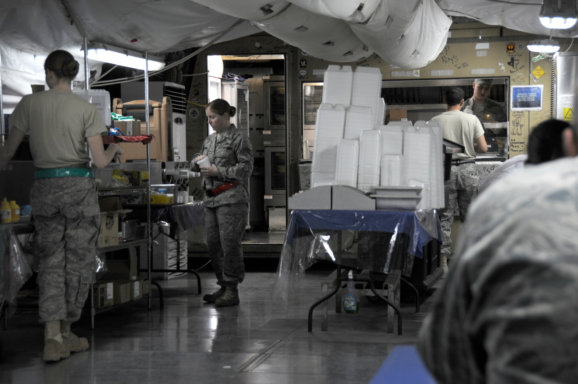 SOUTHWEST ASIA - Members of the 380th Air Expeditionary WIng grab food at Roy's diner on the last night of service for the tent-style dining facility, Feb 14. Roy's Diner, one of the last remaining Air Force tent-style dining facilities in the area of responsibility, will be replaced by a new hardened facility on Feb 15. (U.S. Air Force photo by Staff Sgt. Mike Andriacco) (Released)
