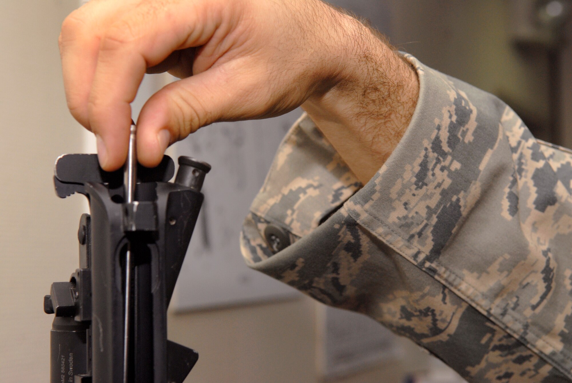 Staff Sergeant Art Lothrop, 379th Expeditionary Security Forces Squadron (ESFS) Combat Arms Training Maintenance (CATM) NCOIC, inserts a bore straightness gauge into the breech of an M4 carbine to insure the barrel meets specs, Feb. 15, 2009, at an undisclosed location in Southwest Asia.  Team members of CATM, issue, inspect, and maintain weapons held in the armory for the base.  Staff Sgt. Lothrop hails from Colfax, Wash. and is deployed from Tyndall Air Force Base, Fla. in support of Operations Iraqi and Enduring Freedom and Combined Joint Task Force - Horn of Africa.   (U.S. Air Force Photo by Airman 1st Class Andrew Satran/Released)