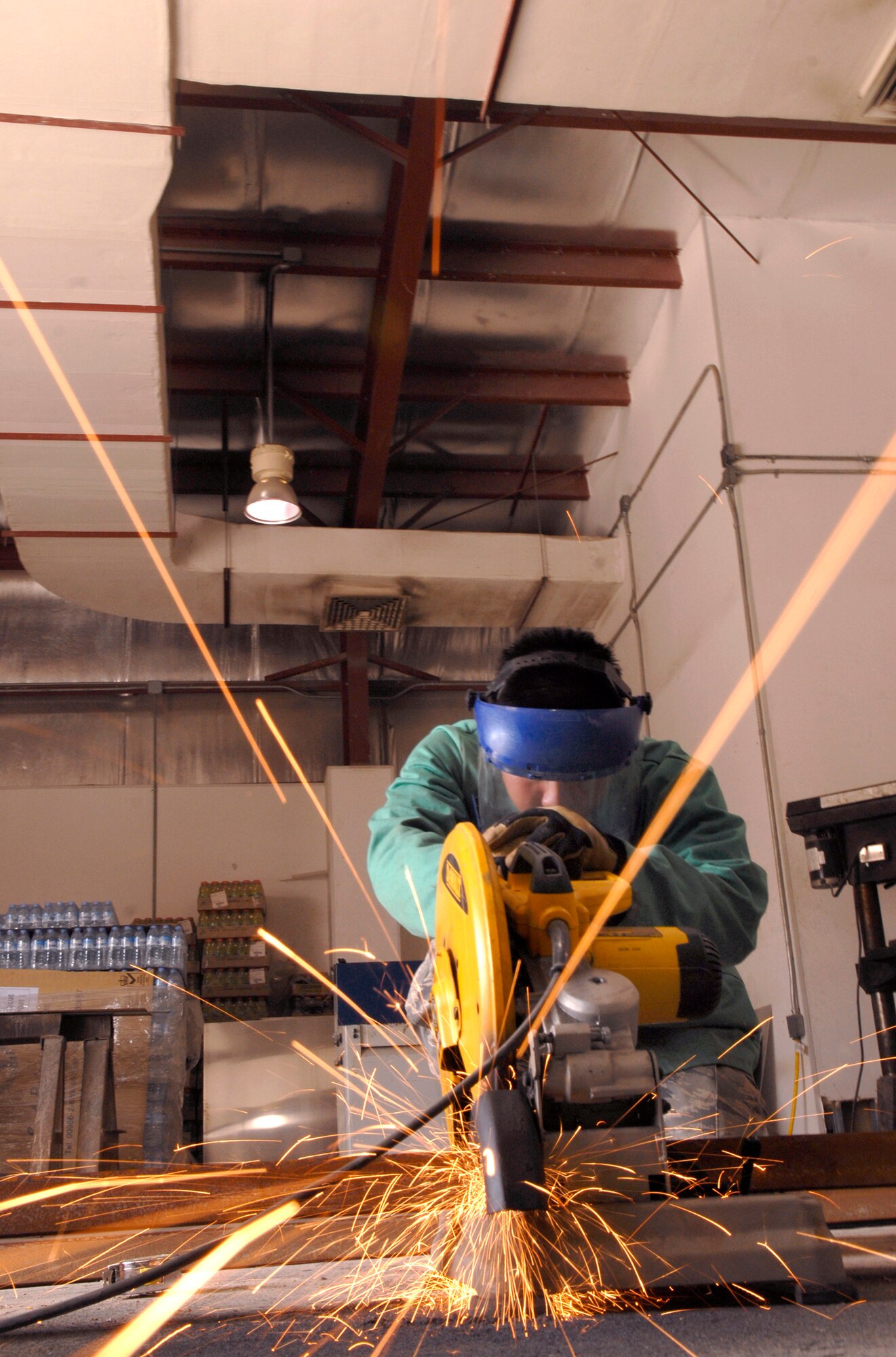 Airman 1st Class Seung Kim, a 379th Expeditionary Civil Engineer Squadron Structural Apprentice, slices through a piece of angle iron which will be used to create a Foreign Object Debris (FOD) checker, Feb. 15, 2009, at an undisclosed location in Southwest Asia.  The FOD checker will facilitate rock removal from vehicle tires at flight line entry control points around the airfield.  Airman 1st Class Kim hails from San Jose, Calif. and is deployed from Travis Air Force Base, Calif. in support of Operation Iraqi and Enduring Freedom and Combined Joint Task Force - Horn of Africa.  (U.S. Air Force Photo by Airman 1st Class Andrew Satran/Released)