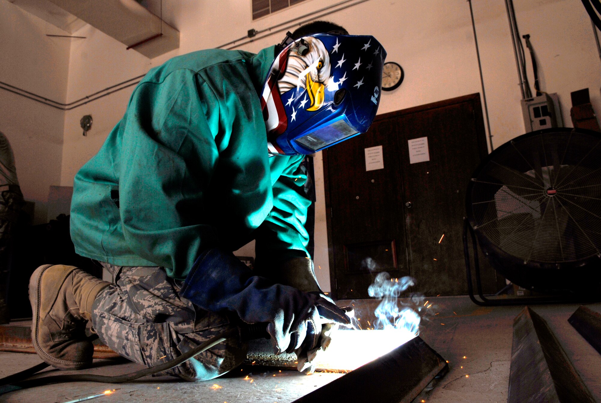 Staff Sergeant Evan Bellamy, a 379th Expeditionary Civil Engineer Squadron Structural Craftsman, welds a Foreign Object Debris (FOD) checker from angle iron beams to facilitate rock removal from vehicle tires at flight line entry control points, Feb. 15, 2009, at an undisclosed location in Southwest Asia.  Staff Sgt. Bellamy hails from Sullivan County, N.Y. and is deployed from Dover Air Force Base, Del. in support of Operation Iraqi and Enduring Freedom and Combined Joint Task Force - Horn of Africa.  (U.S. Air Force Photo by Airman 1st Class Andrew Satran/Released)