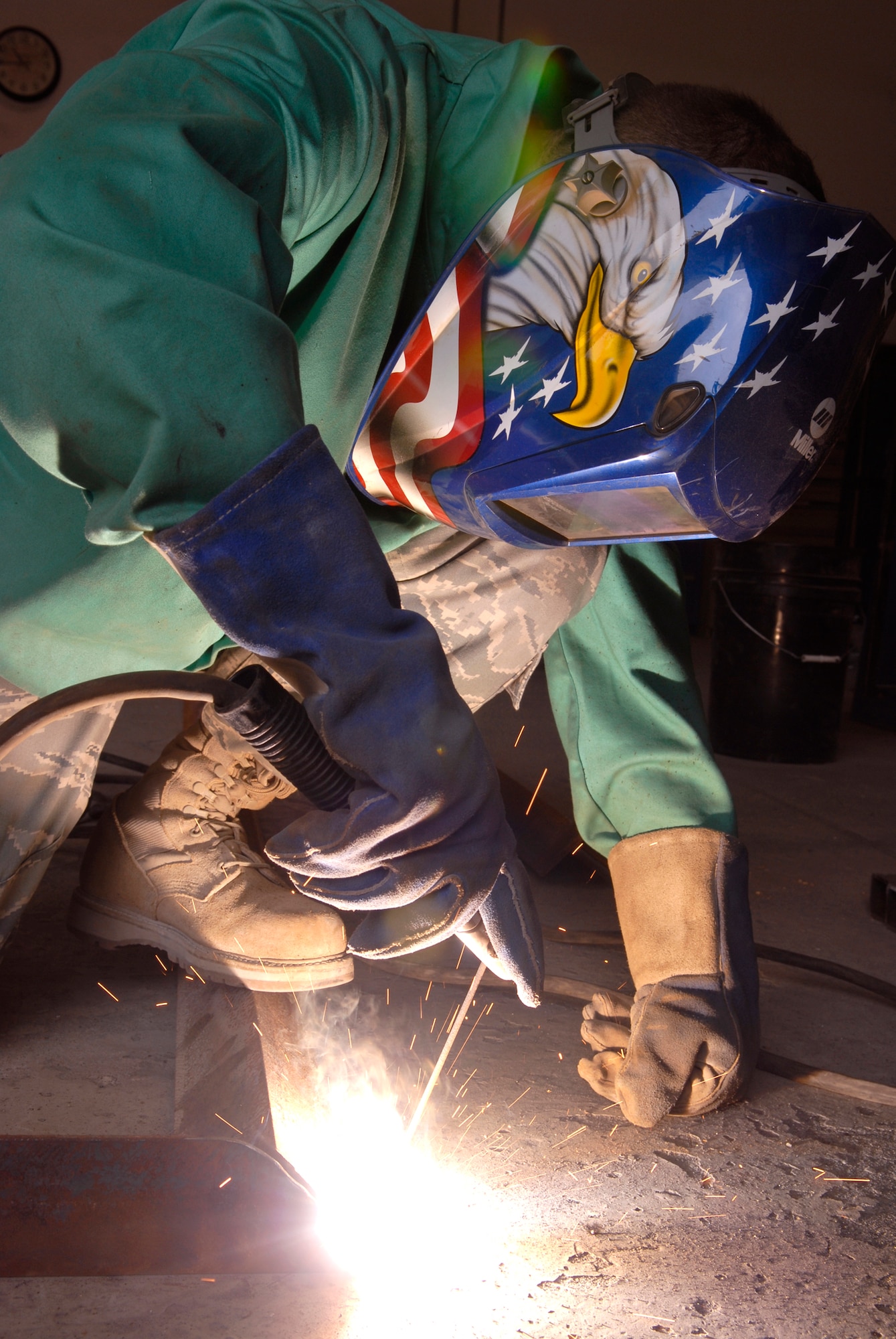 Staff Sergeant Evan Bellamy, a 379th Expeditionary Civil Engineer Squadron Structural Craftsman, welds a Foreign Object Debris (FOD) checker from angle iron beams to facilitate rock removal from vehicle tires at flight line entry control points, Feb. 15, 2009, at an undisclosed location in Southwest Asia.  Staff Sgt. Bellamy hails from Sullivan County, N.Y. and is deployed from Dover Air Force Base, Del. in support of Operation Iraqi and Enduring Freedom and Combined Joint Task Force - Horn of Africa.  (U.S. Air Force Photo by Airman 1st Class Andrew Satran/Released)