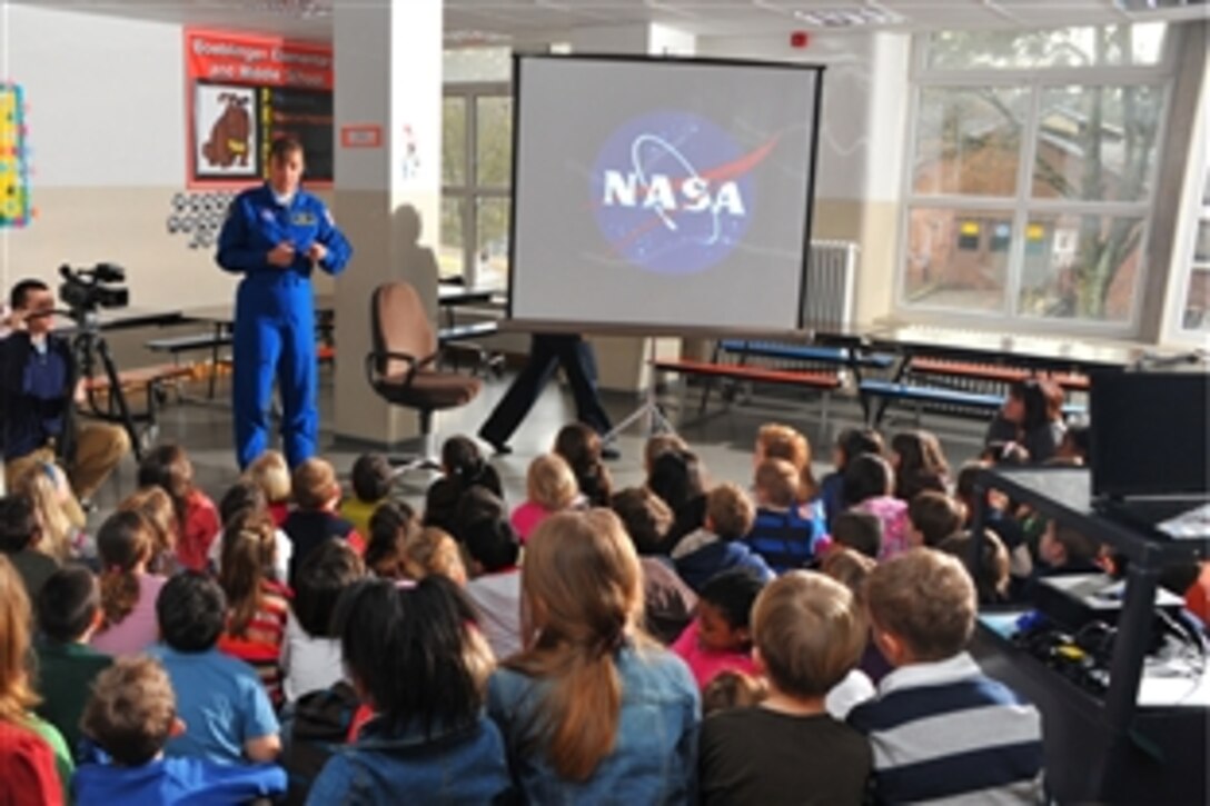 U.S. Navy Capt. Heidemarie M. Stefanyshyn-Piper, who is a NASA astronaut, speaks to a 4th Grade class at Boeblingen Elementary/Middle School on Panzer Kaserne in Boblingen, Germany. Stefanyshyn-Piper showed photos from her two trips into space.