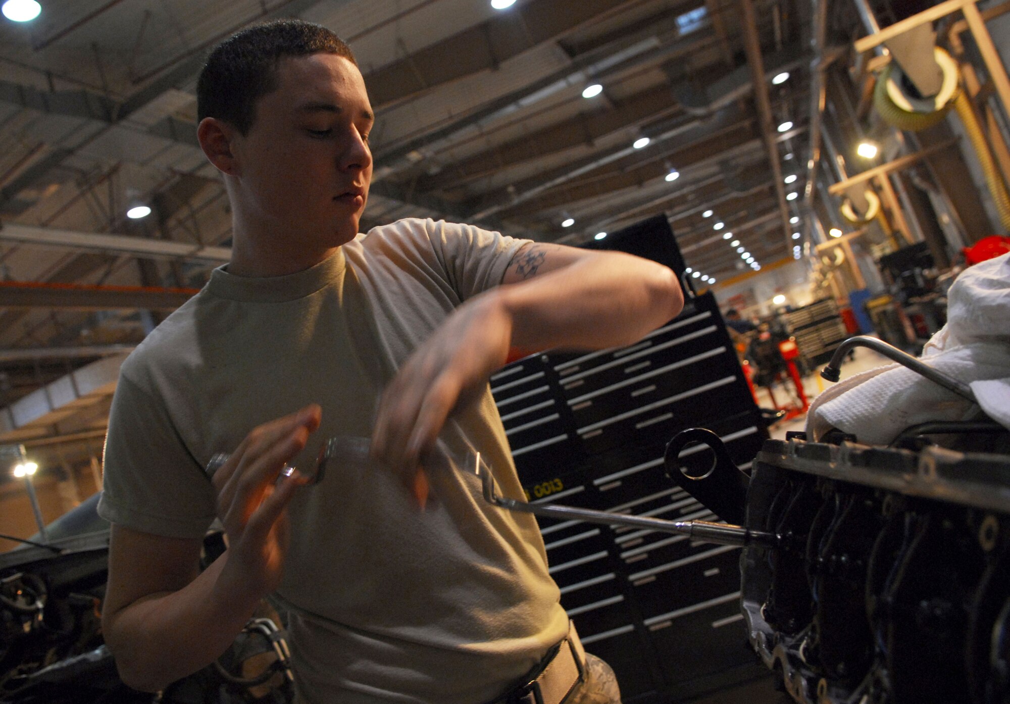 Senior Airman Casey Van Veckhoven dismantles a cylinder head from a turbo diesel engine at Osan AB Republic of Korea Feb. 3.  Airman Van Veckhoven is a vehicle mechanic assigned to the 51st Logistics Readiness Squadron. (U.S. Air Force photo/ Senior Airman Christopher Boitz)