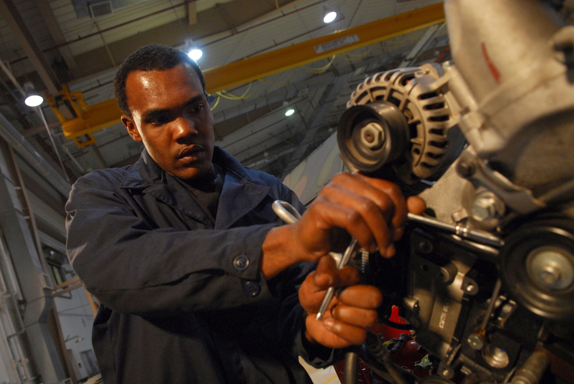 Staff Sgt. Cavin Browne reassembles the cooling system on a turbo-diesel engine at Osan AB Republic of Korea Feb. 3. Sergeant Browne is a vehicle mechanic assigned to the 51st Logistics Readiness Squadron. (U.S. Air Force photo/Senior Airman Christopher Boitz)