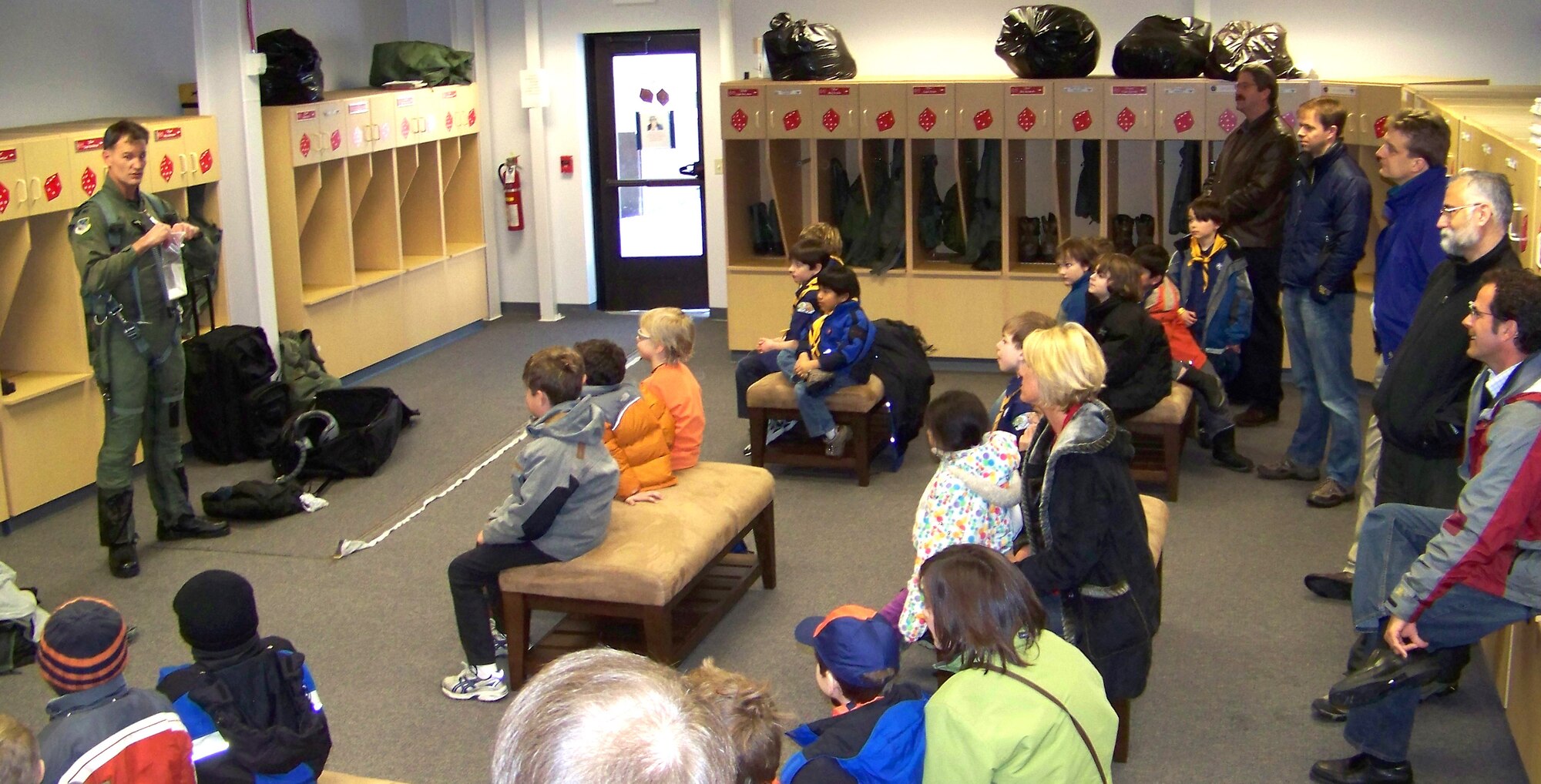 ELMENDORF AIR FORCE BASE, Alaska -- Col Eric Overturf, 477th Fighter Group Commander, briefs 20 Cub Scouts (ages 6-10 years) from Den #1 of Pack 227.  Col Overturf talks about gear an F-22A Raptor pilot needs when they fly.  The 477th Fighter Group is Air Force Reserve Command's first F-22A Raptor unit and the first Reserve flying unit based in the Pacific theater of operations.  (US Air Force Photo by Capt Lisa Reaver)
