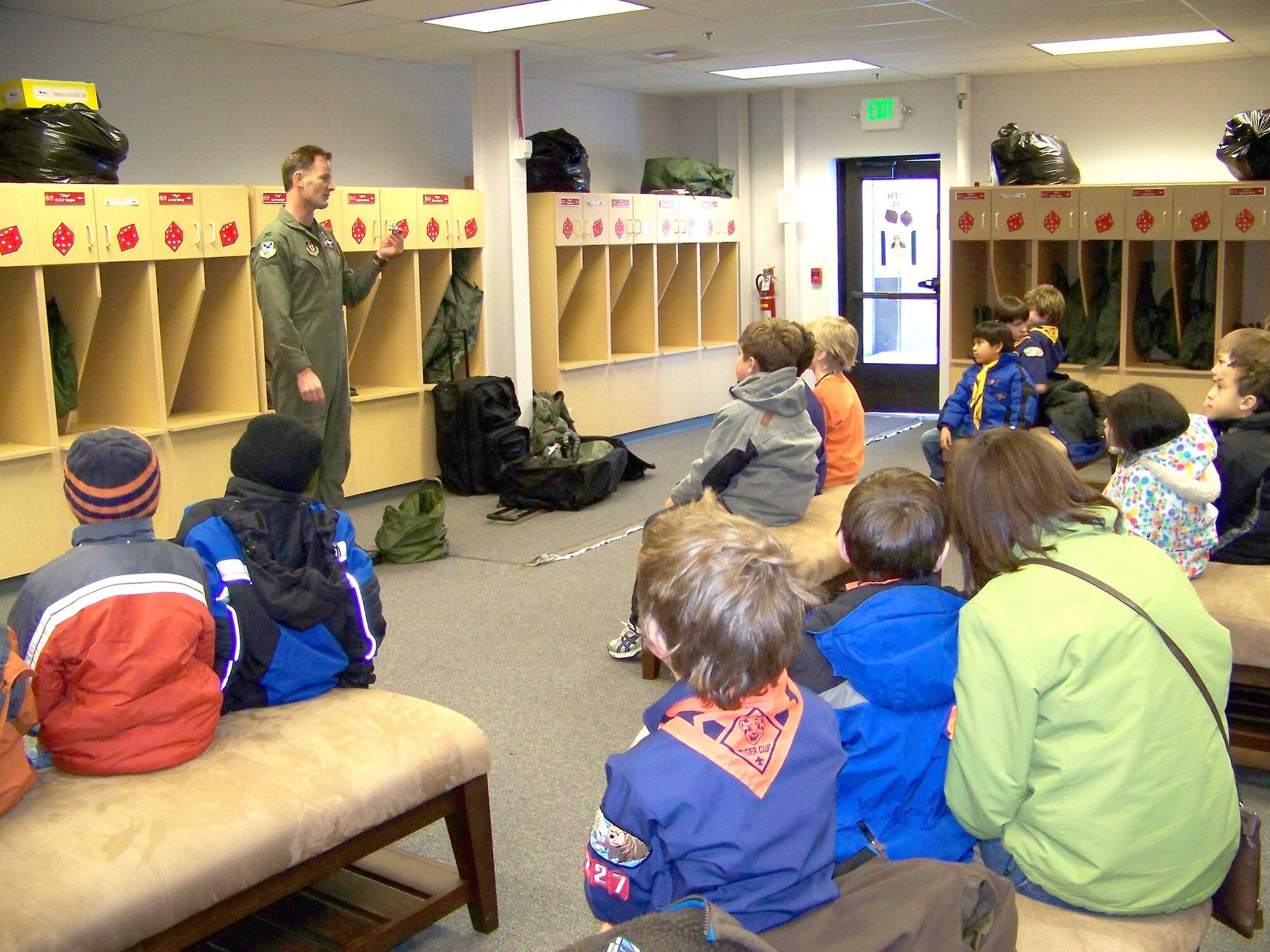 ELMENDORF AIR FORCE BASE, Alaska -- Col Eric Overturf, 477th Fighter Group Commander, briefs 20 Cub Scouts (ages 6-10 years) from Den #1 of Pack 227.  Col Overturf talks about gear an F-22A Raptor pilot needs when they fly.  The 477th Fighter Group is Air Force Reserve Command's first F-22A Raptor unit and the first Reserve flying unit based in the Pacific theater of operations.  (US Air Force Photo by Capt Lisa Reaver)