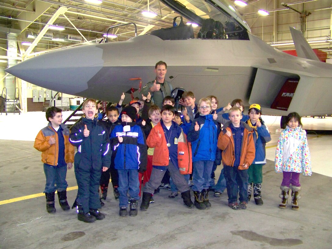 ELMENDORF AIR FORCE BASE, Alaska -- Col Eric Overturf, 477th Fighter Group Commander, poses with 20 Cub Scouts (ages 6-10 years) from Den #1 of Pack 227.  Col Overturf briefed the scouts about gear an F-22A Raptor pilot needs when they fly and gave a walk-around tour of the F-22.  The 477th Fighter Group is Air Force Reserve Command's first F-22A Raptor unit and the first Reserve flying unit based in the Pacific theater of operations.  (US Air Force Photo by Capt Lisa Reaver)