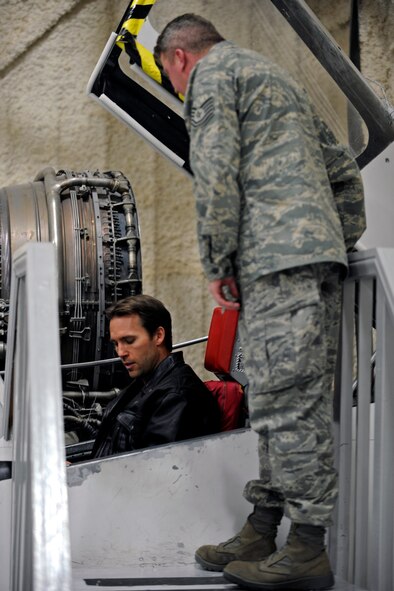 Tech. Sgt. Steven Wilson, 28th Bomb Wing Public Affairs NCO in charge, explains a F-106 Delta Dart simulator to Colby Donaldson, host of Speed Channel's "American Thunder" , during filming for an episode at the South Dakota Air and Space Museum, Feb. 11. Mr. Donaldson toured the museum's airpark, interior exhibits and the museums's archive area during filming for a segment of an upcoming episode. (U.S. Air Force photo/Airman 1st Class Matthew Flynn)