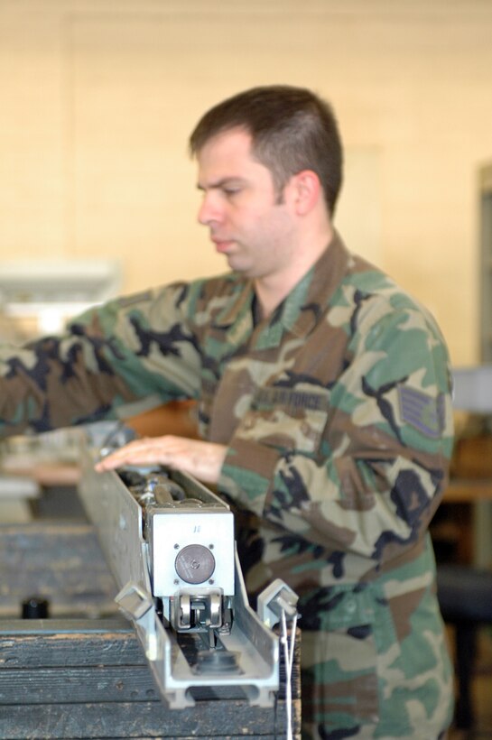 Staff Sgt. Gregory Torrens, a weapons technician with the 162nd Armament Flight, disassembles and inspects a LAU-129 launcher from an F-16 Fighting Falcon for a required 18-month inspection. (Air National Guard photo by Staff Sgt. Desiree Twombly)