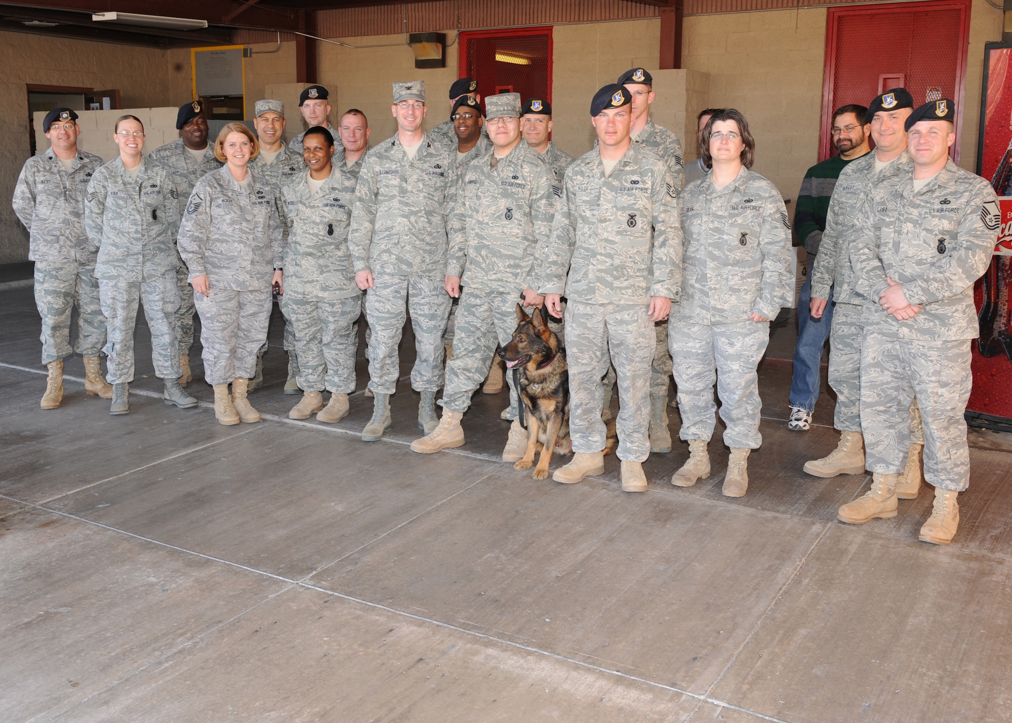 Staff Sgt. Noe Gutierrez, 49th Security Forces Squadron and his military working dog, Bill, pose for a group photo with Col. Stephen DiFonzo, 49th Mission Support Group commander and other members of the 49 SFS on his return to Holloman Air Force Base, N.M., Feb. 9. Sergeant Gutierrez returned from a 179-day deployment. (U.S. Air Force photo/Senior Airman Michael Means)