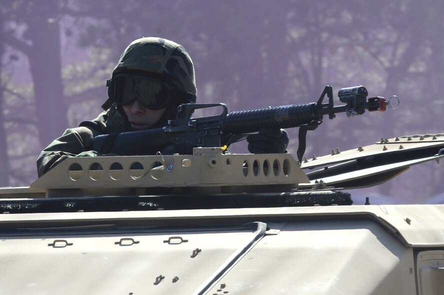 Master Sgt. Eric Gibson, a student in the Air Force Advanced Contingency Skills Training Course, reacts to a scenario during convoy operations training on Feb. 17, 2009, at a range on Fort Dix, N.J.  The course is taught by the U.S. Air Force Expeditionary Center's 421st Combat Training Squadron, also at Fort Dix.  The course prepares Airmen for upcoming deployments through training in everything from convoy operations and combat first aid to patrolling and tactics.  (U.S. Air Force Photo/Staff Sgt. Nathan Bevier)