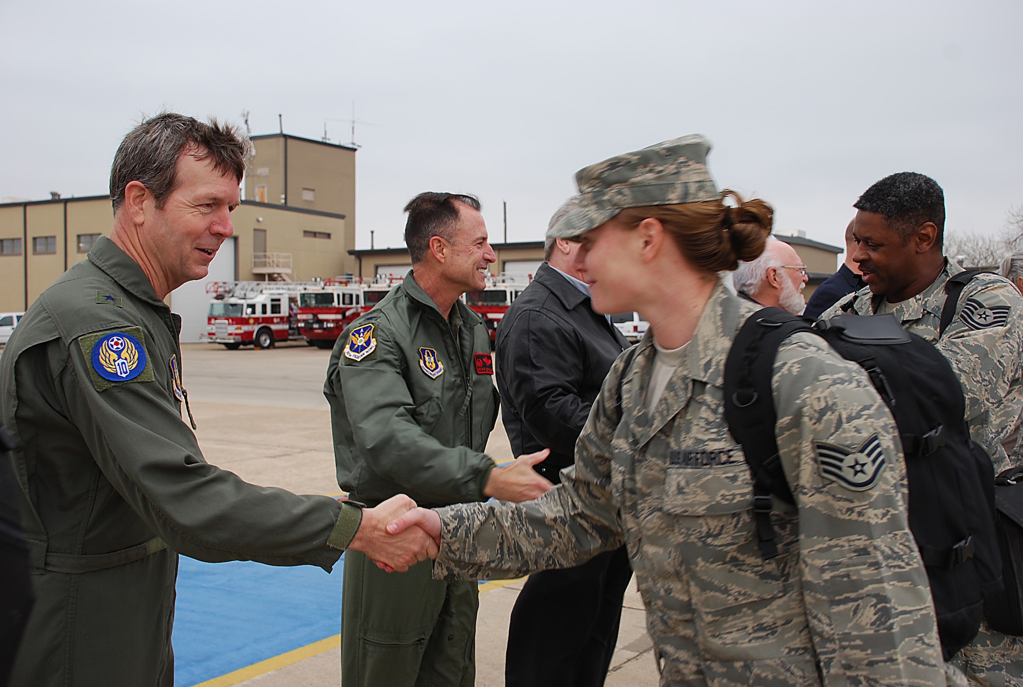 Maj. Gen. TC Coon, 10th Air Force commander (left), and Col. Kevin C. Pottinger, 301st Fighter Wing commander (center), bid farewell and safe journey to more than 100 301FW members as they board aircraft bound for Southwest Asia. The troops have deployed in support of Operation Iraqi Freedom and will return in the spring. General Coon pinned on his second star Feb. 20. (U.S. Air Force Photo/Tech. Sgt. Julie Briden-Garcia)