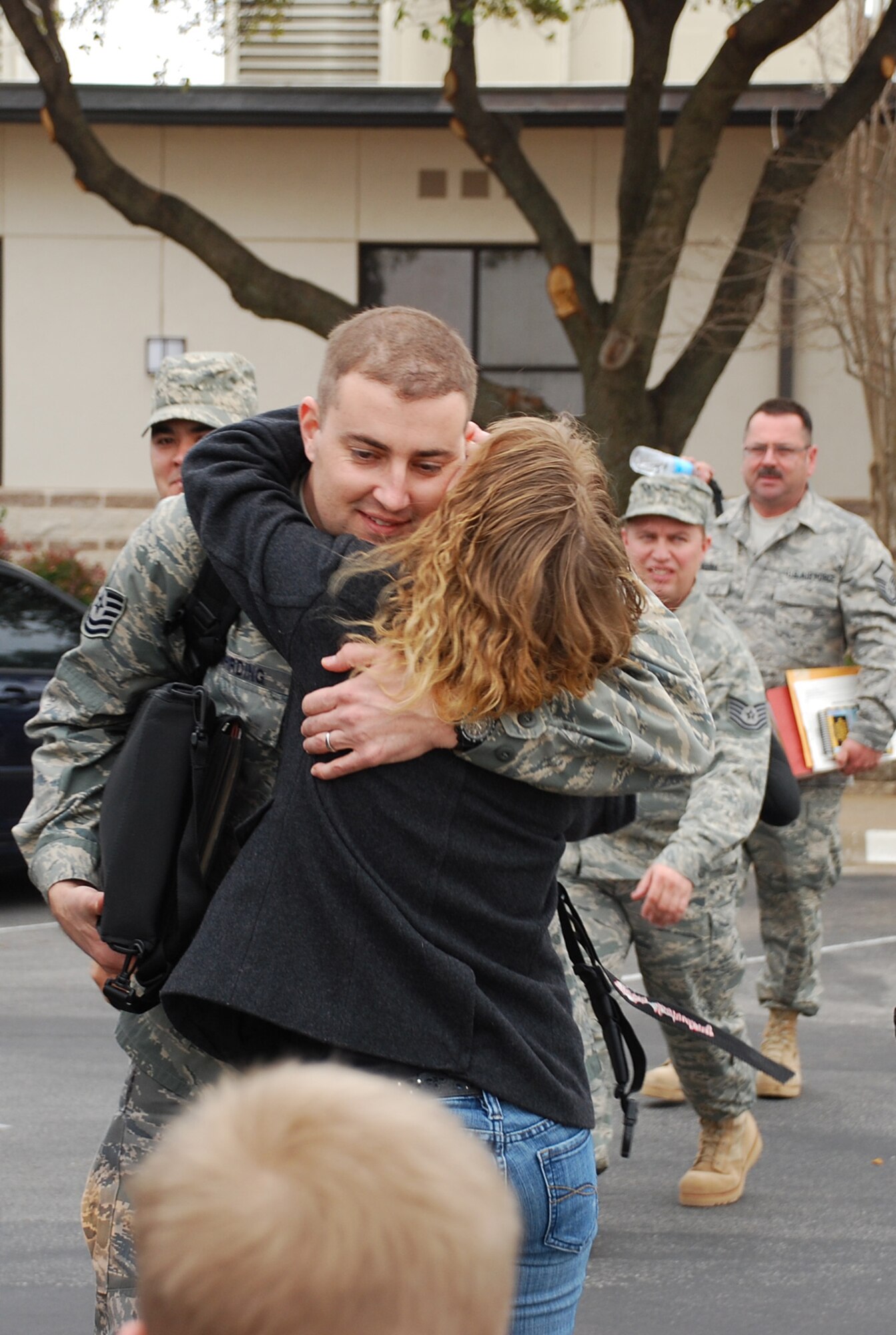 Getting one last hug, one of more than 100 301st Fighter Wing members prepare to board the bus that took them to the awaiting contract aircraft. The troops have deployed in support of Operation Iraqi Freedom and will return in the spring. (U.S. Air Force Photo/Tech. Sgt. Julie Briden-Garcia)