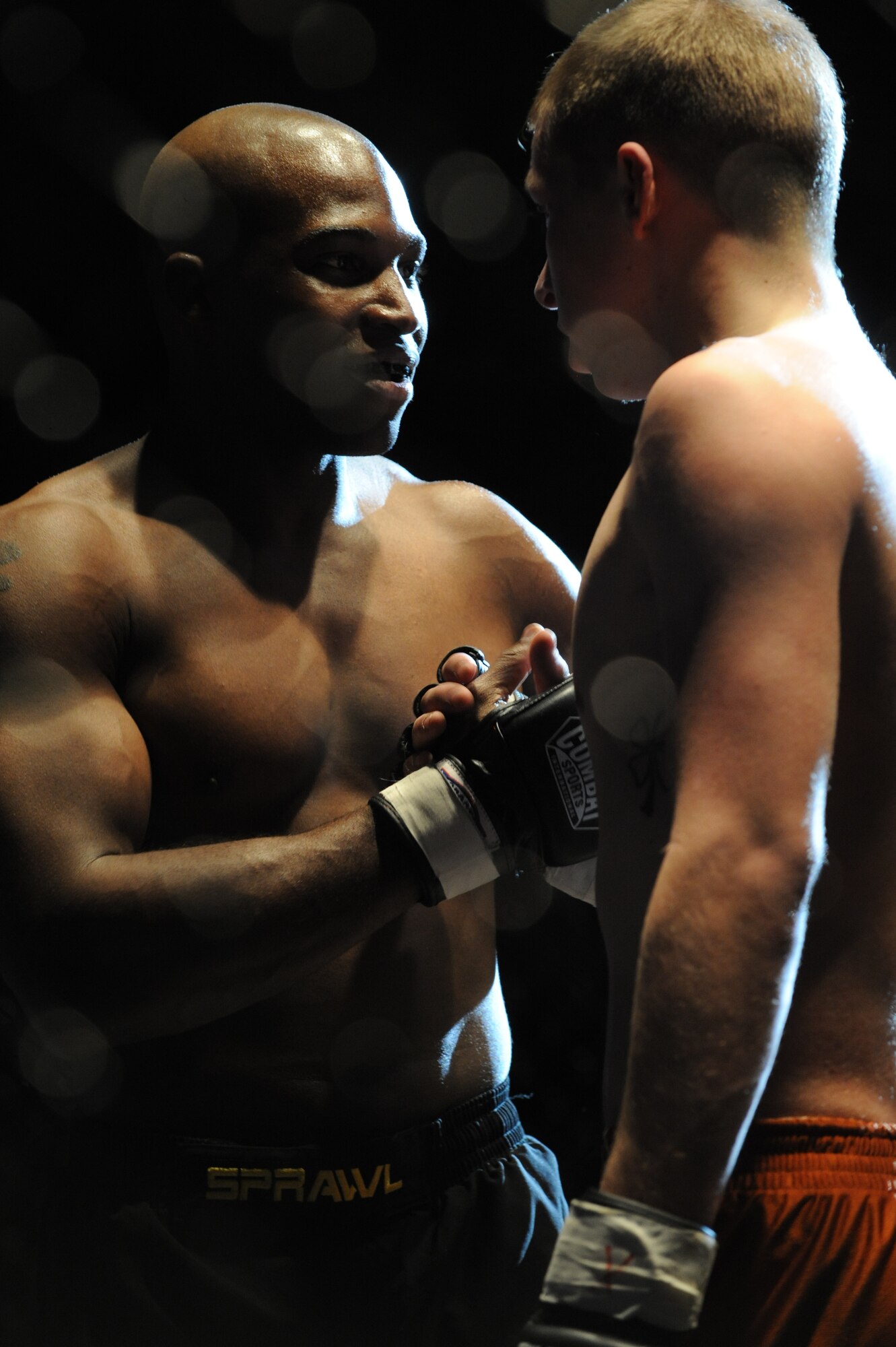 (Left) Second Lt. Jason Carter, 28th Medical Group group practice manager, shakes Hugh Foreman’s hand after defeating him in the first round of their match at the Rushmore Plaza Civic Center in Rapid City, S.D., Feb. 13. Lieutenant Carter’s debut amateur match was the fifth of 15 matches held during the mixed martial arts competition. (U.S. Air Force photo/Airman 1st Class Adam Grant)