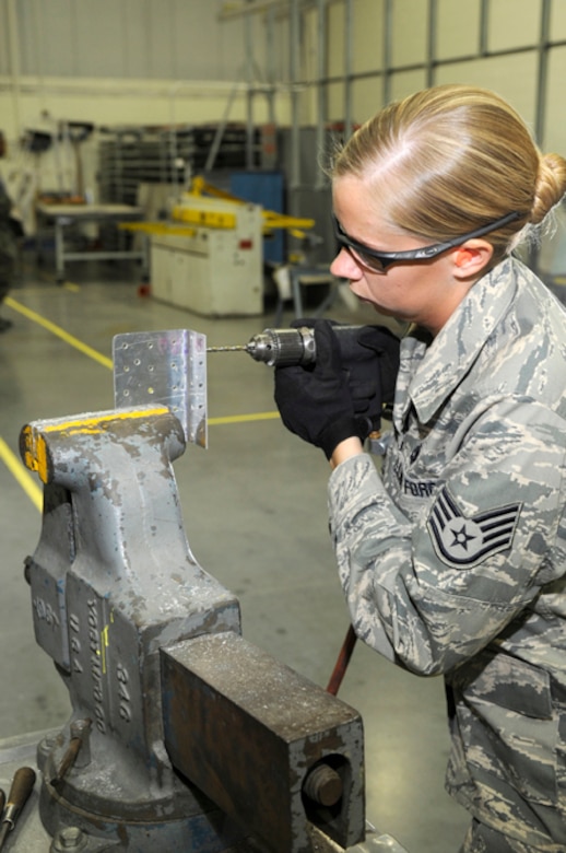 Staff Sgt. Lynn Plemons, 305th Maintenance Squadron Maintenance Fabrication Flight training manager, re-fabricates an aircraft part by drilling a rivet pattern on a piece meant for a KC-10. The primary mission of the sheet metal shop is to ensure structural integrity of KC-10 and C-17 airframes. (U.S. Air Force photo/Carlos Cintron)