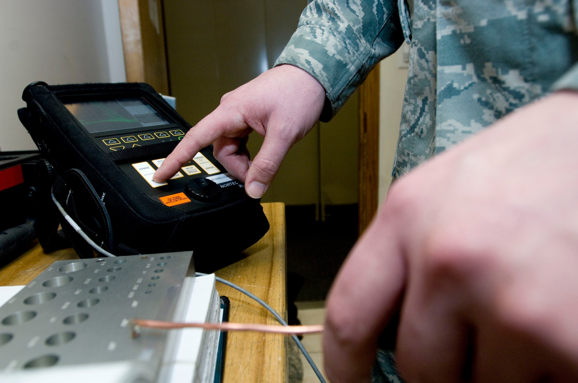 ELMENDORF AIR FORCE BASE, Alaska -- Senior Airman Zach Pierce, 3rd Equipment Maintenance Squadron, post calibrates eddy current Feb. 13, 2009. Airman Pierce uses eddy current, a nondestructive inspection, to indicate a crack on the part. (U.S. Air Force photo/Senior Airman Jonathan Steffen)