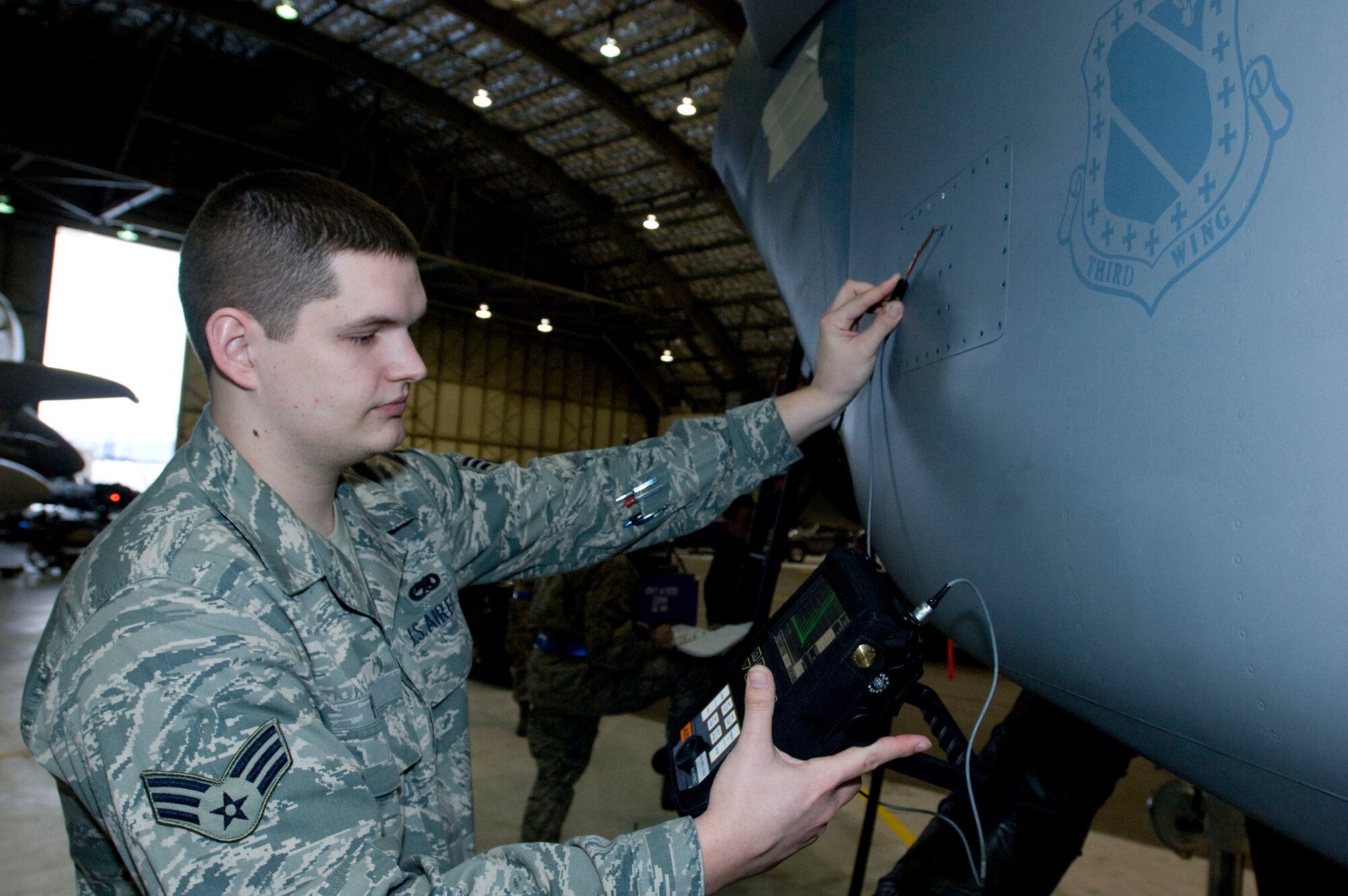 ELMENDORF AIR FORCE BASE, Alaska -- Senior Airman Zach Pierce, 3rd Equipment Maintenance Squadron, uses eddy current inspection on C-17 Globemaster III Feb. 13, 2009. Airman Pierce uses eddy current, a nondestructive inspection, to indicate a crack on the part. (U.S. Air Force photo/Senior Airman Jonathan Steffen)