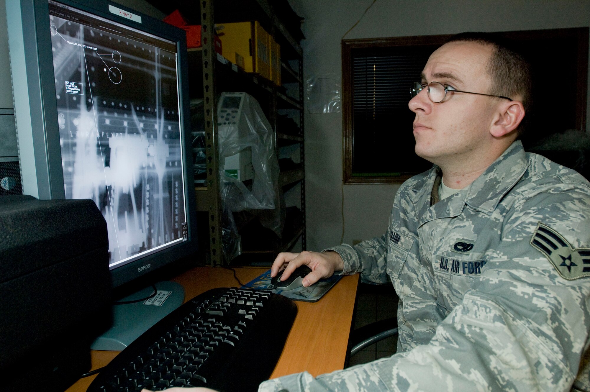 ELMENDORF AIR FORCE BASE, Alaska -- Senior Airman Daniel Craigo, 3rd Equipment Maintenance Squadron, looks over an X-ray of variable ramp on an F-15 Feb. 13, 2009. Airman Craigo uses X-ray as a nondestructive inspection to indicate foreign object damage to aircraft parts. (U.S. Air Force photo by Senior Airman Jonathan Steffen)