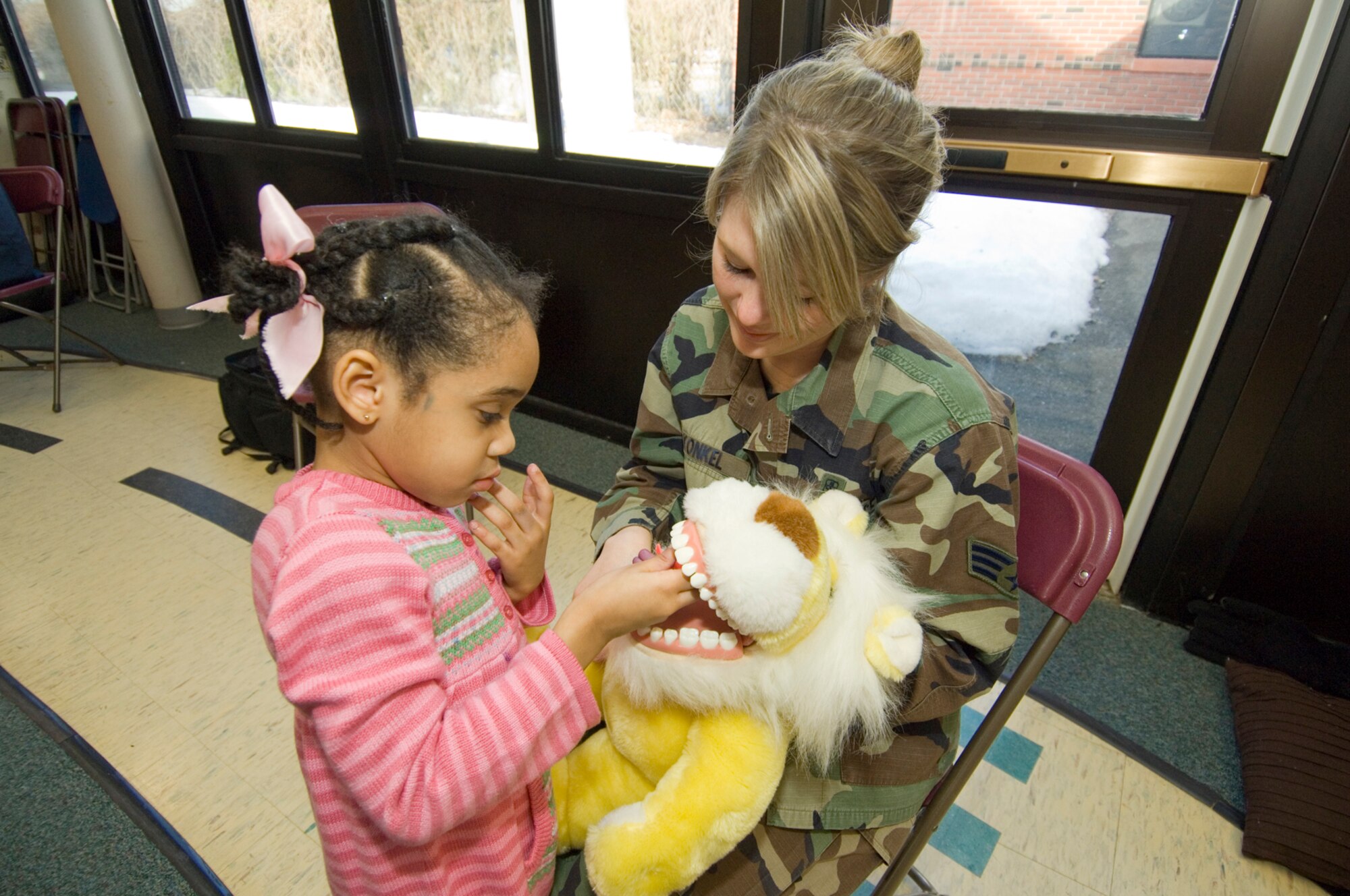 HANSCOM AIR FORCE BASE, Mass. – Ashlei Brook Cleaves (left) learns the proper technique for flossing teeth from Senior Airman Jessica Konkel with the 66th Medical Group, Dental Clinic, on Feb. 9 at the Child Development Center. Members of the Dental Clinic spoke to pre-school classes at the Child Development Center and the Hanscom Primary School in celebration of National Children’s Dental Health Month. 
(U.S. Air Force photo by Rick Berry)

