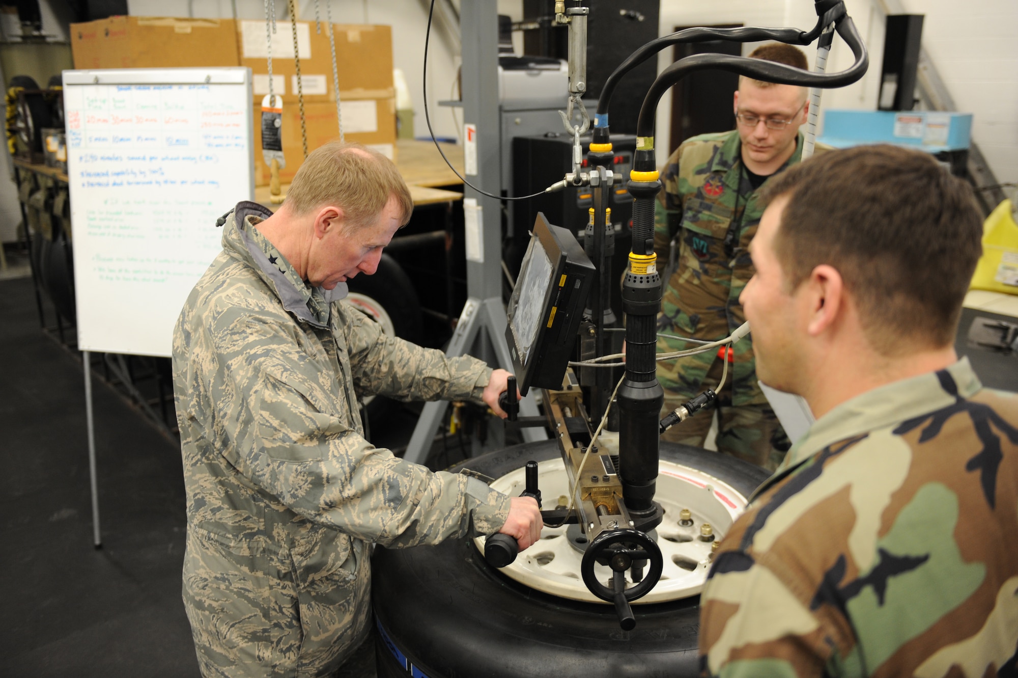 WHITEMAN AIR FORCE BASE, Mo. – Lt. Gen. Ronald Sams, Inspector General of the Air Force, operates a universal wheel build-up stand and torque machine used to service aircraft wheels and tires while touring the wheel and tire facility Feb. 13.  The tour was given by Tech. Sgt. Heath Marinello and Airman 1st Class Nigel Kuhl, 509th Aircraft Maintenance Squadron crew chief. General Sams visited Whiteman as the guest speaker for the Maintenance Professional of the Year ceremony. (U.S. Air Force photo/Staff Sgt. Charles Larkin)  