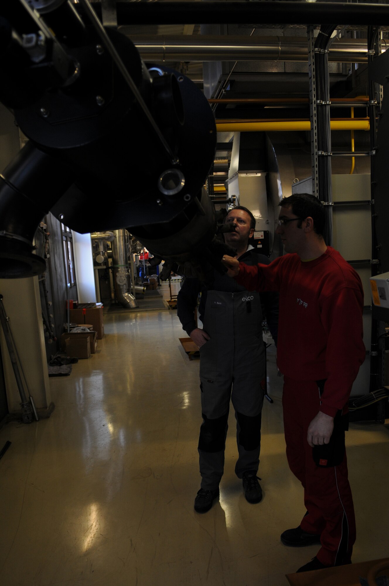 Mathias Barz (left) and Uli Jung perform a bi-annual inspection on a heating burner in Heat Plant One that was disassembled Feb. 12, 2009, at Ramstein Air Base. The heat plant has been supplying heat to the buildings of Ramstein since 1997 and continues to help support the mission. (U.S. Air Force photo by Airman 1st Class Caleb Pierce)