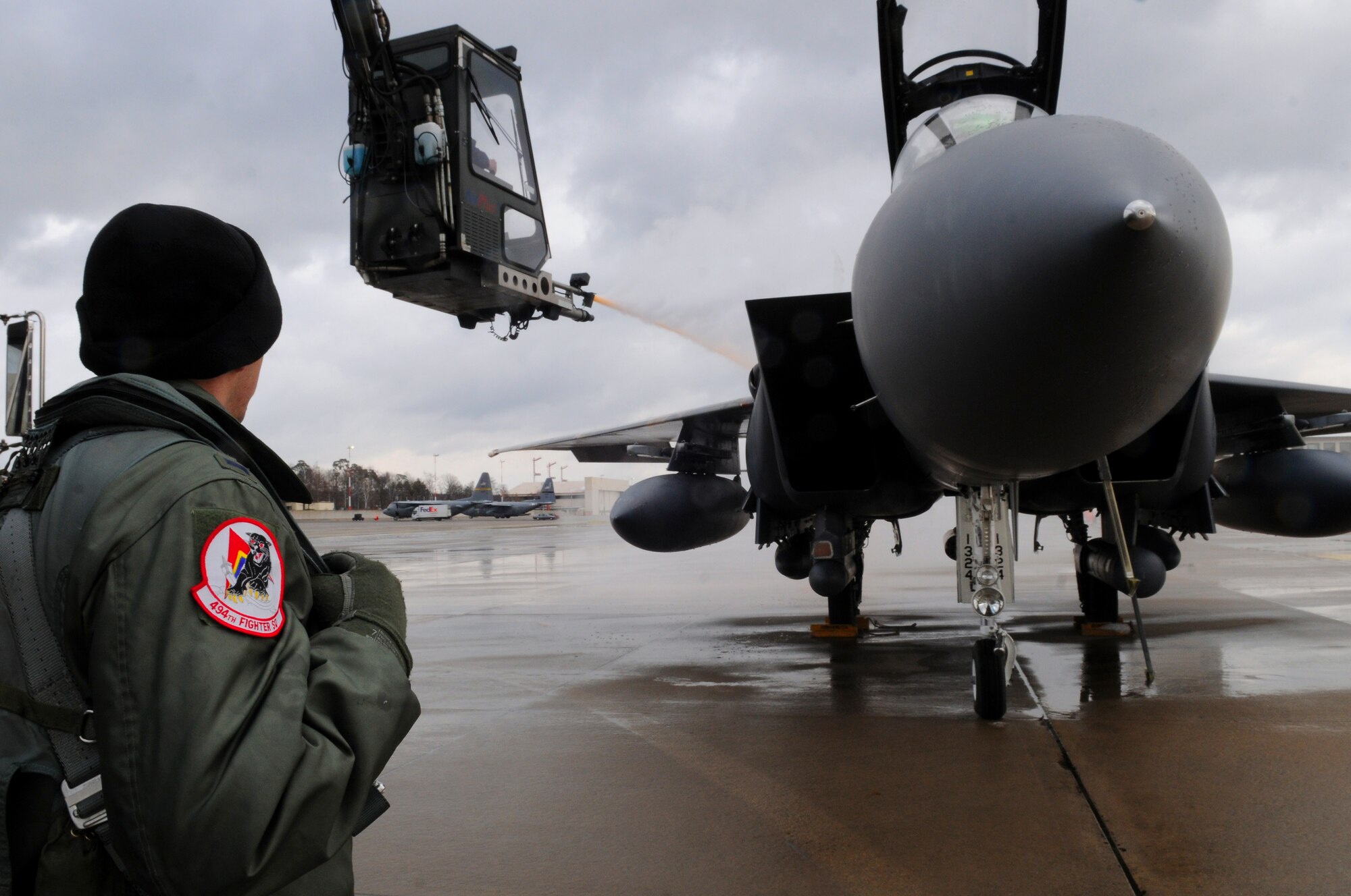 The pilot of an F-15 E Strike Eagle watches his aircraft get de-iced before departure on the Ramstein Air Base flightline Feb. 12, 2009. The F-15 was being prepared to head back to its home base at Royal Air Force Lakenheath, England. (U.S. Air Force photo by Airman 1st Class Grovert Fuentes-Contreras)