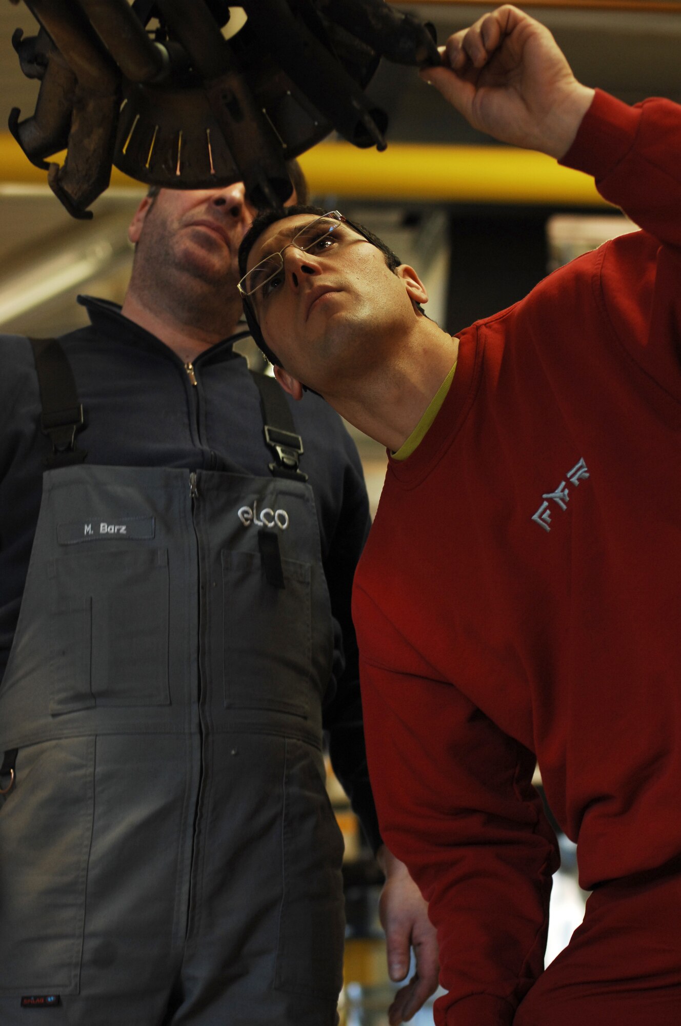Mathias Barz (left) and Uli Jung perform a bi-annual inspection on a heating burner that was disassembled in Heat Plant One Feb. 12, 2009, at Ramstein Air Base. The heat plant has been supplying heat to the buildings of Ramstein since 1997 and continues to help support the mission. (U.S. Air Force photo by Senior Airman Amber Bressler)