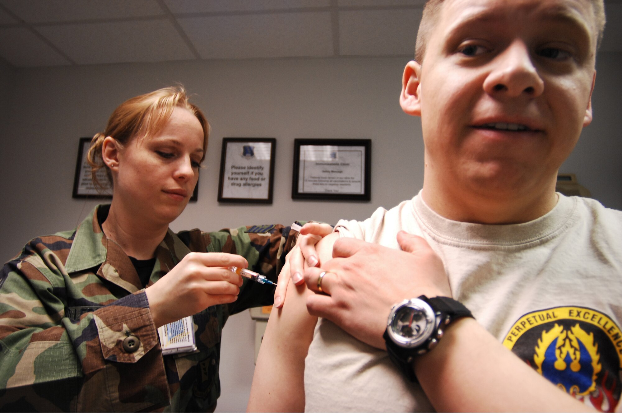 Staff Sgt. Jennifer Wollersheim, 435th Medical Operations Squadron allergy immunizations technician, gives routine immunizations to Maj. Joseph Wingo, 435th Communications Squadron flight commander, Feb. 11, 2009, at Ramstein Air Base. The 435th MDOS annually processes about 15,000 appointments and treats an average of 4,800 patients. (U.S. Air Force photo by Senior Airman Amber Bressler)