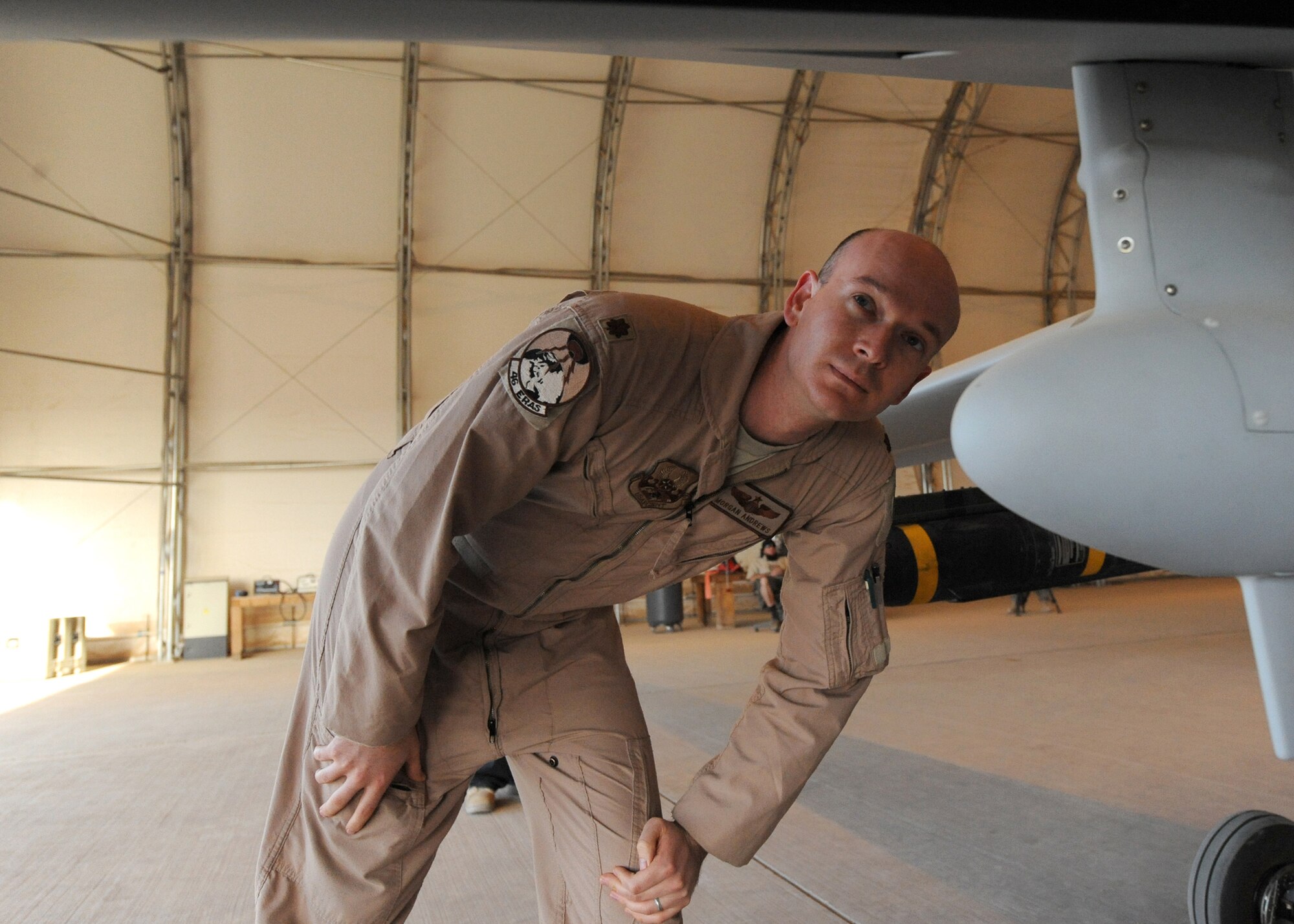 Maj. Morgan Andrews, the 46th Reconnaissance and Attack Squadron director of operations at Joint Base Balad, Iraq, inspects an unmanned MQ-1 Predator before its first flight from the base Feb. 13.  The Predator system is made up of the ground-control system, a satellite link, personnel and the aircraft.  Major Andrews is deployed from Creech Air Force Base, Nev. (U.S. Air Force photo/Senior Airman Tiffany Trojca)
